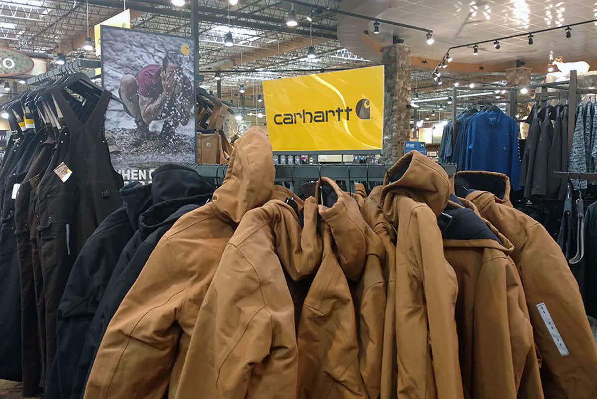 A rack of Carhartt jackets inside a Cabela's store.