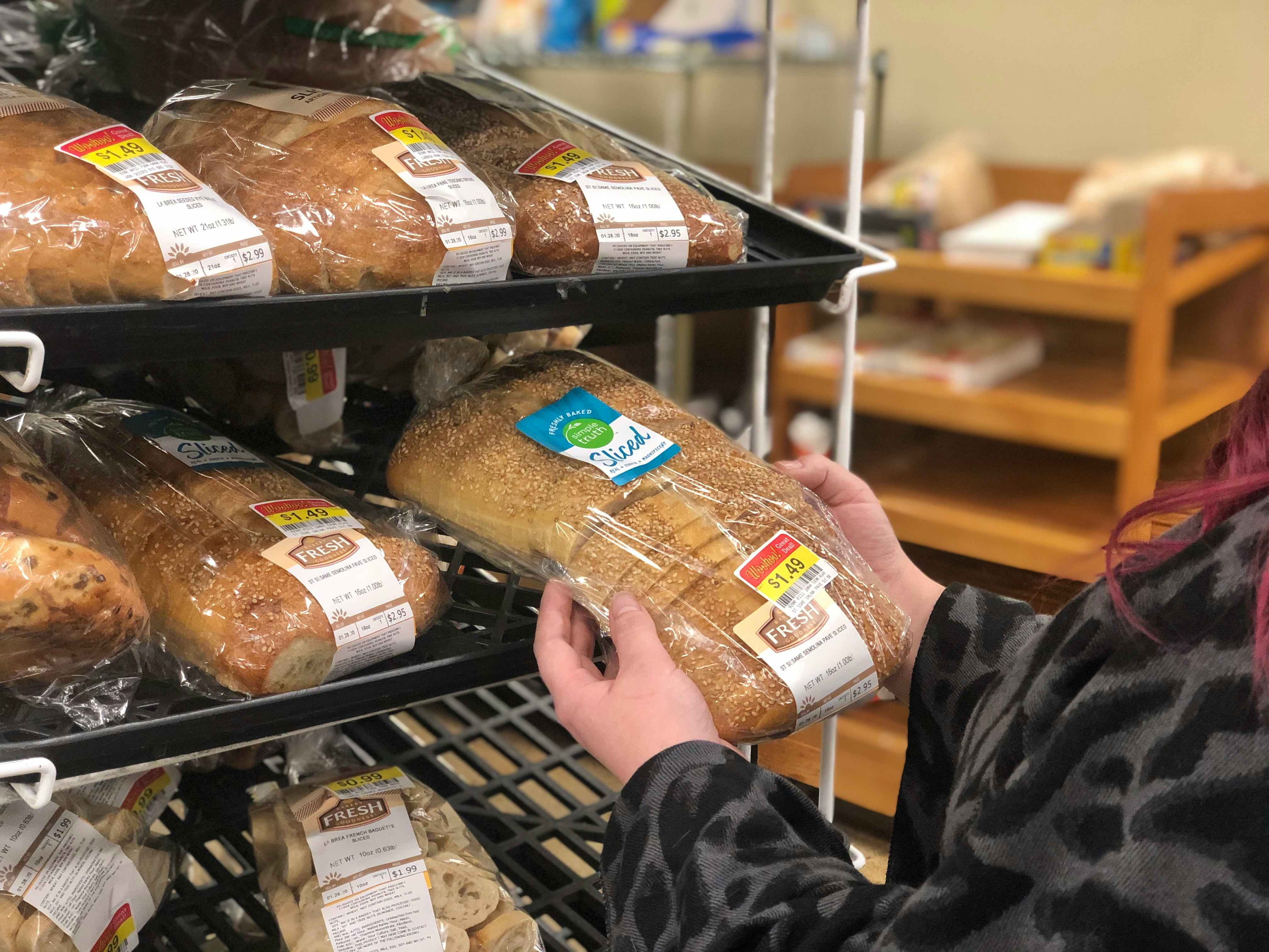 A woman shops for bread in the clearance section.