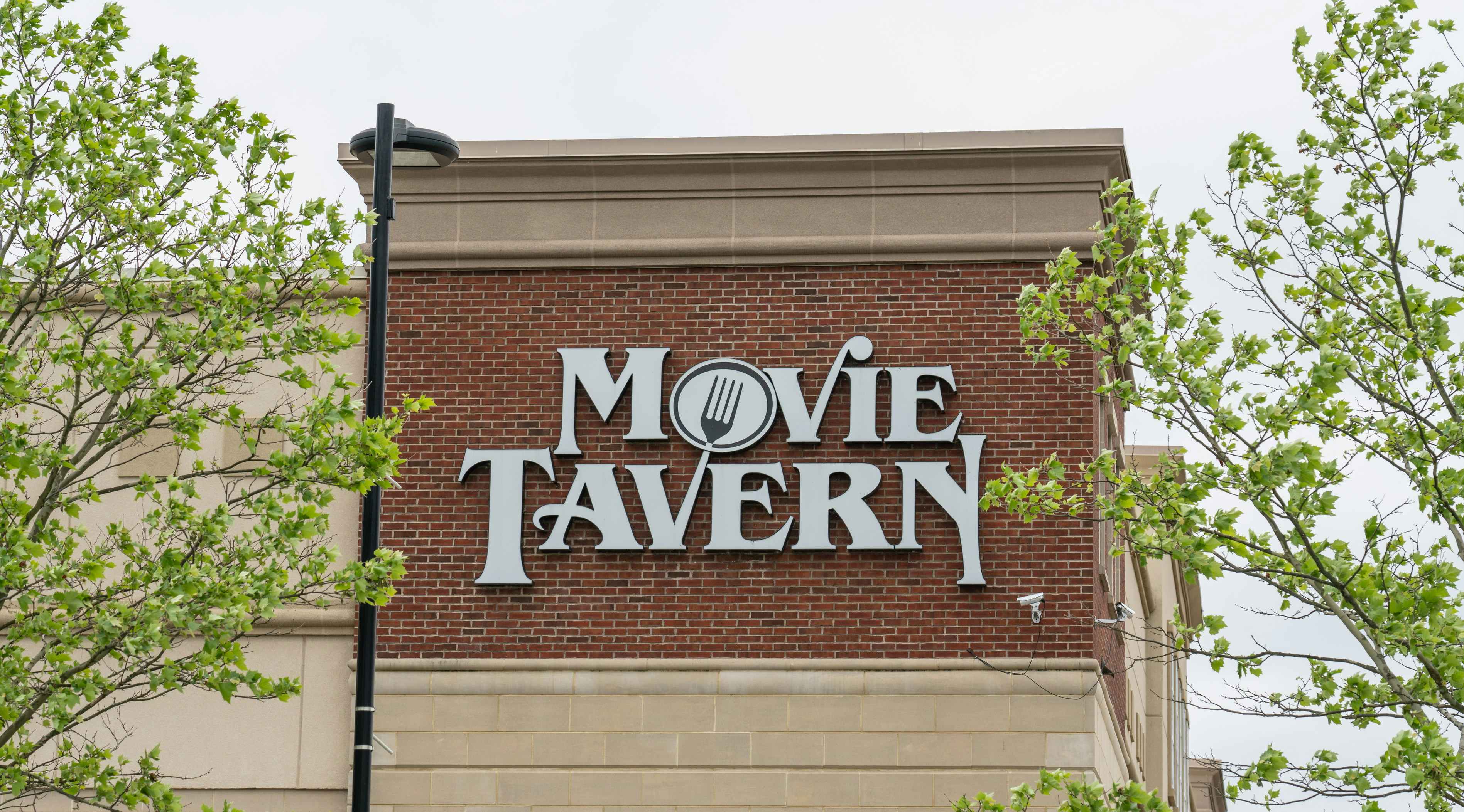 View of Marcus Theatre and Movie Tavern's logo on a brick wall