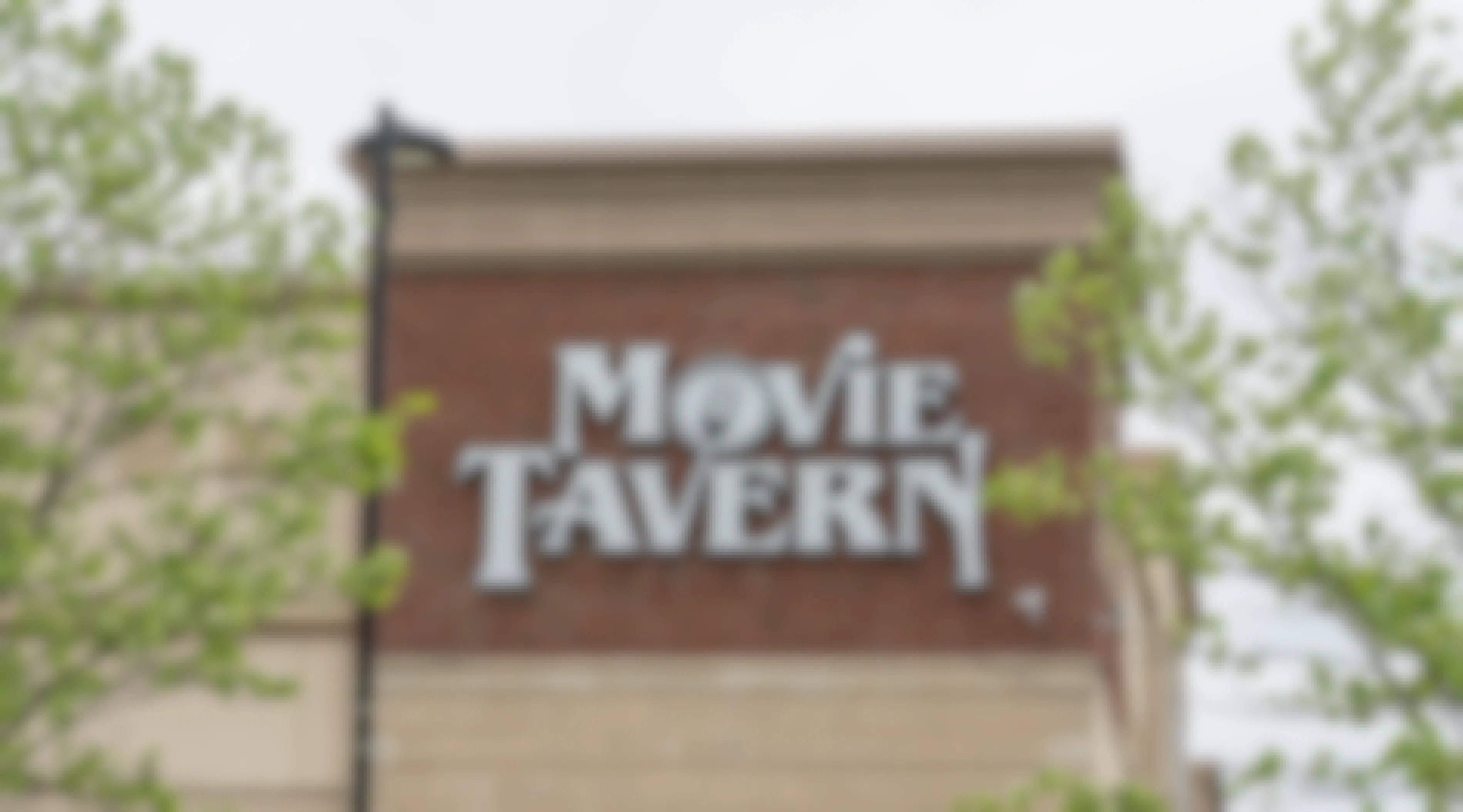View of Marcus Theatre and Movie Tavern's logo on a brick wall