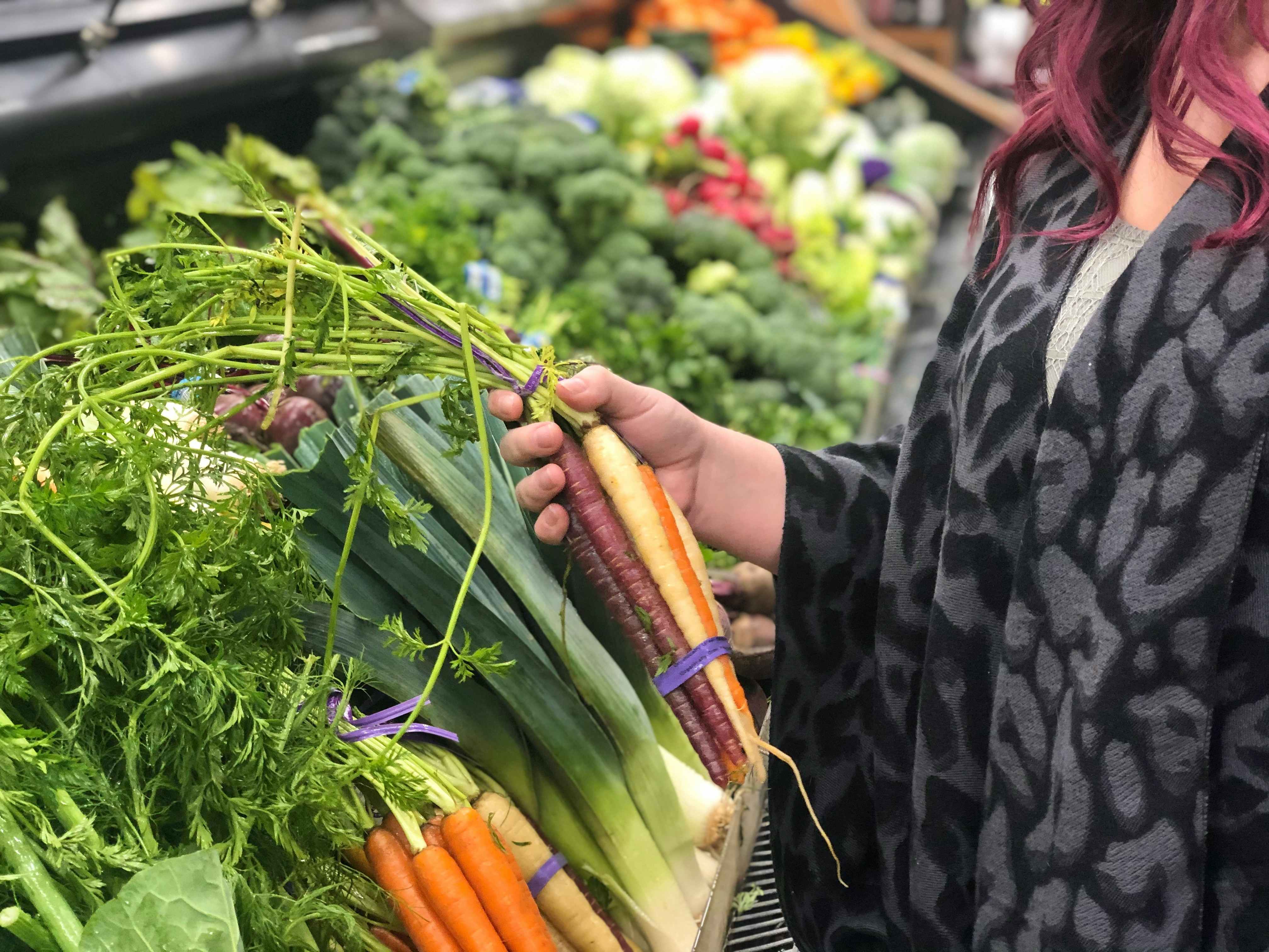 A woman shopping in the produce section.