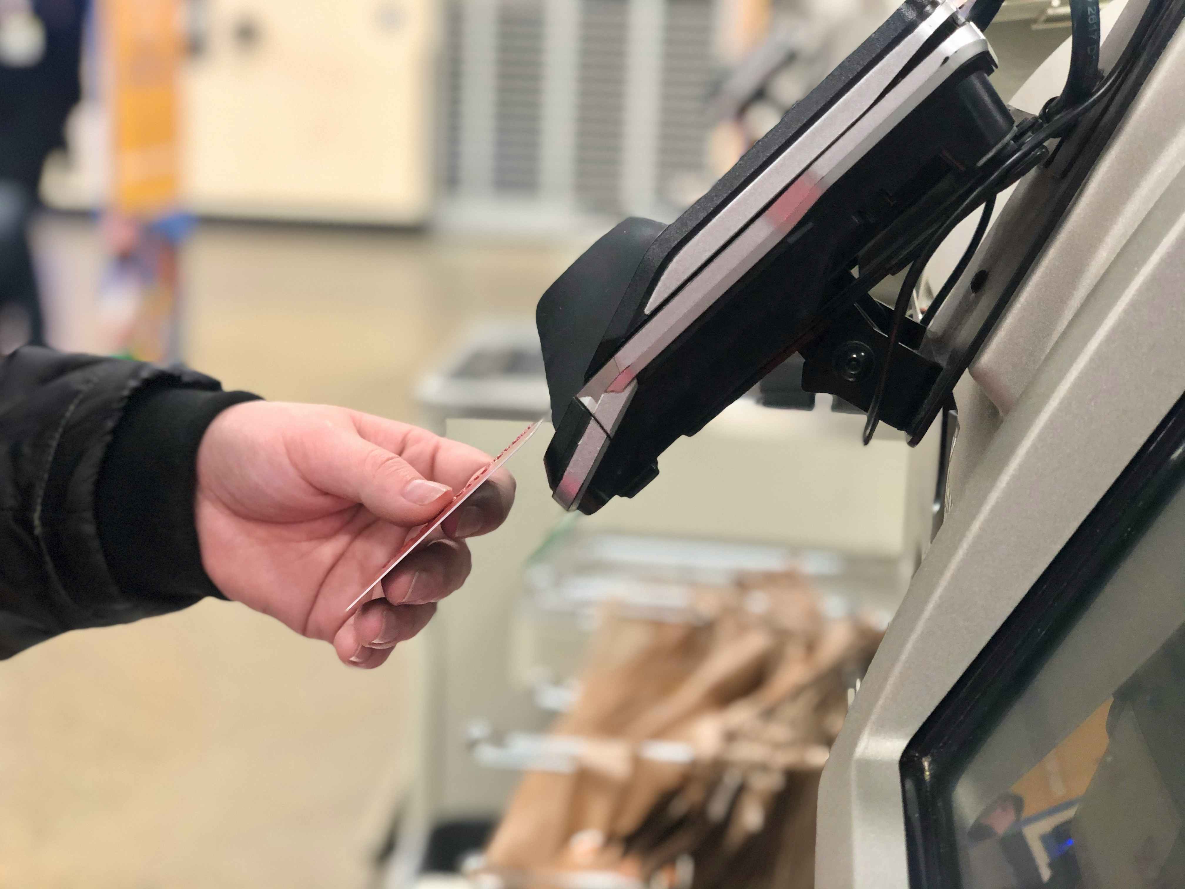shopper paying at store checkout with credit card