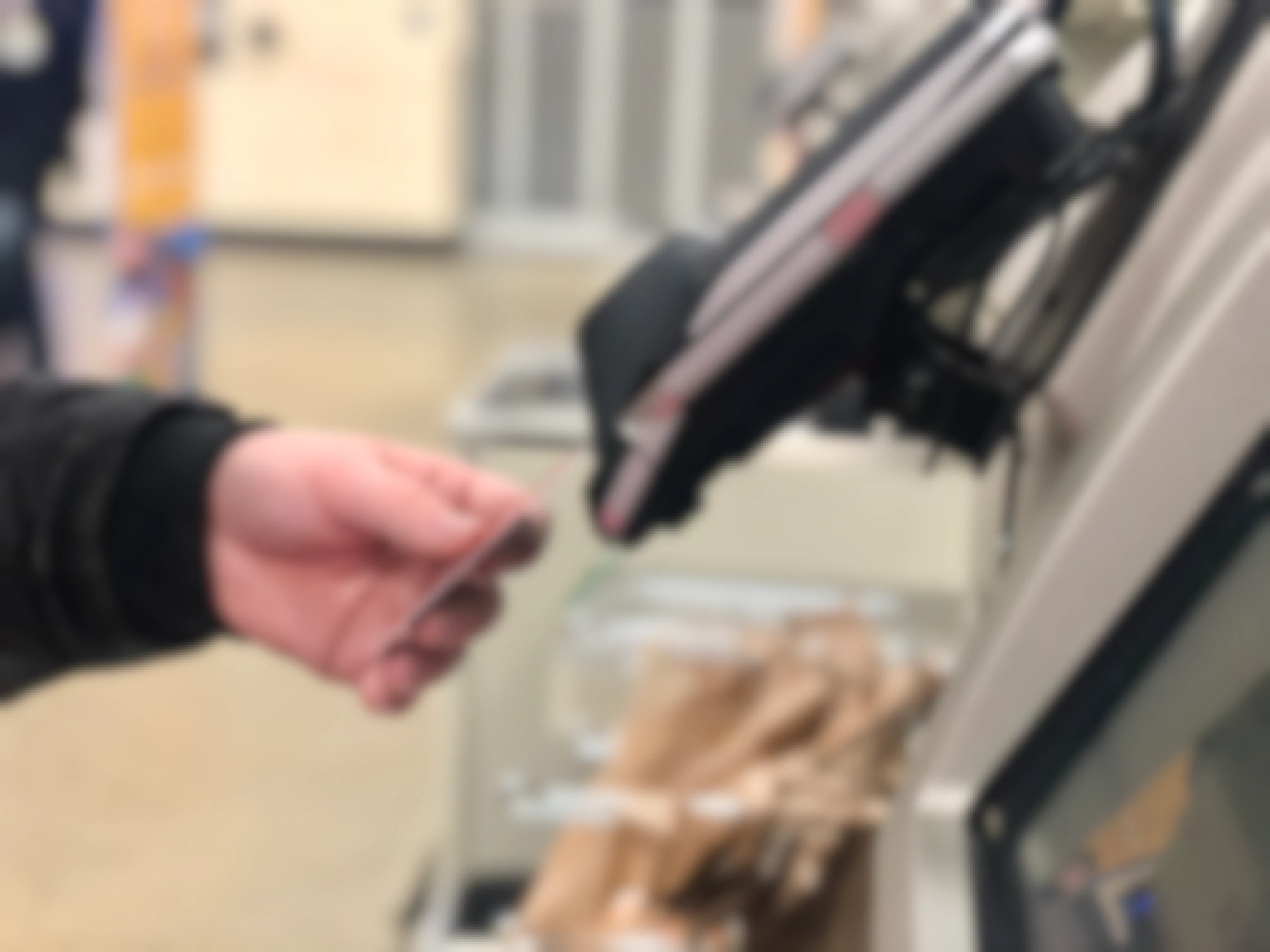 shopper paying at store checkout with credit card