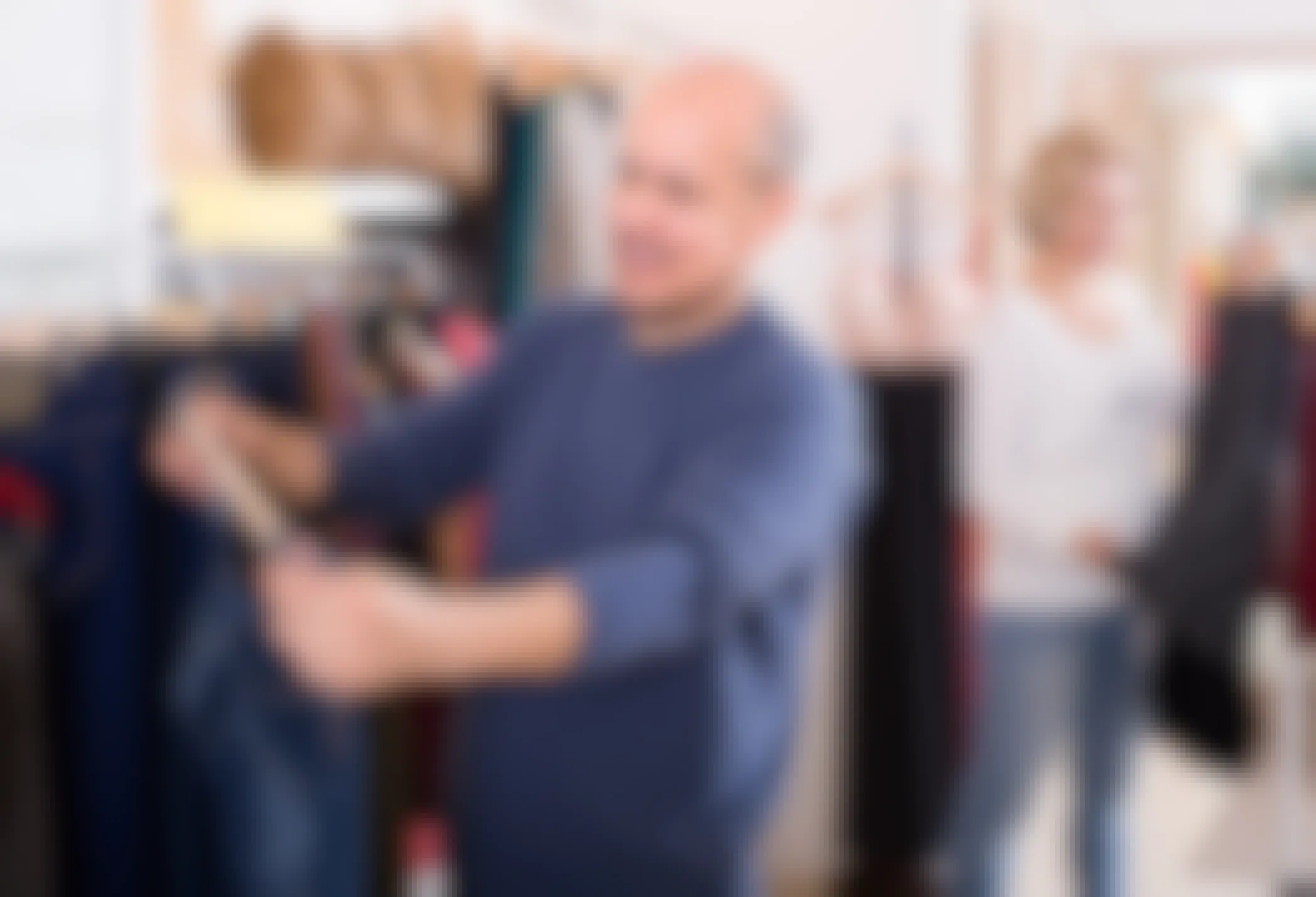 senior spouses buying pair of classic jeans in boutique