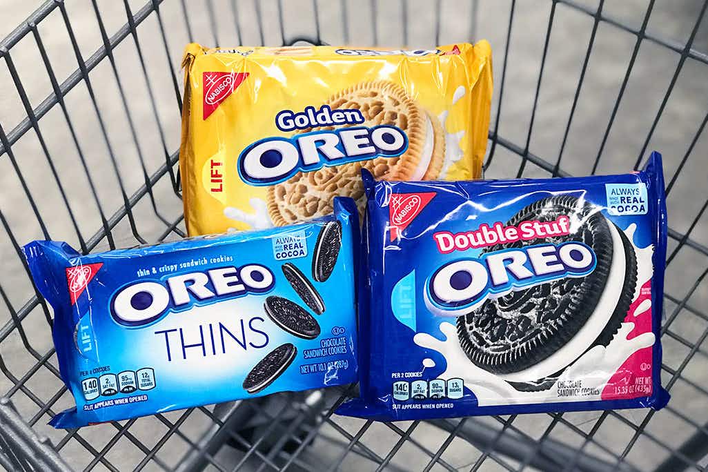 Three packages of different Oreos in a shopping cart