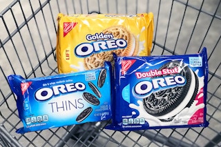 Three packages of different Oreos in a shopping cart