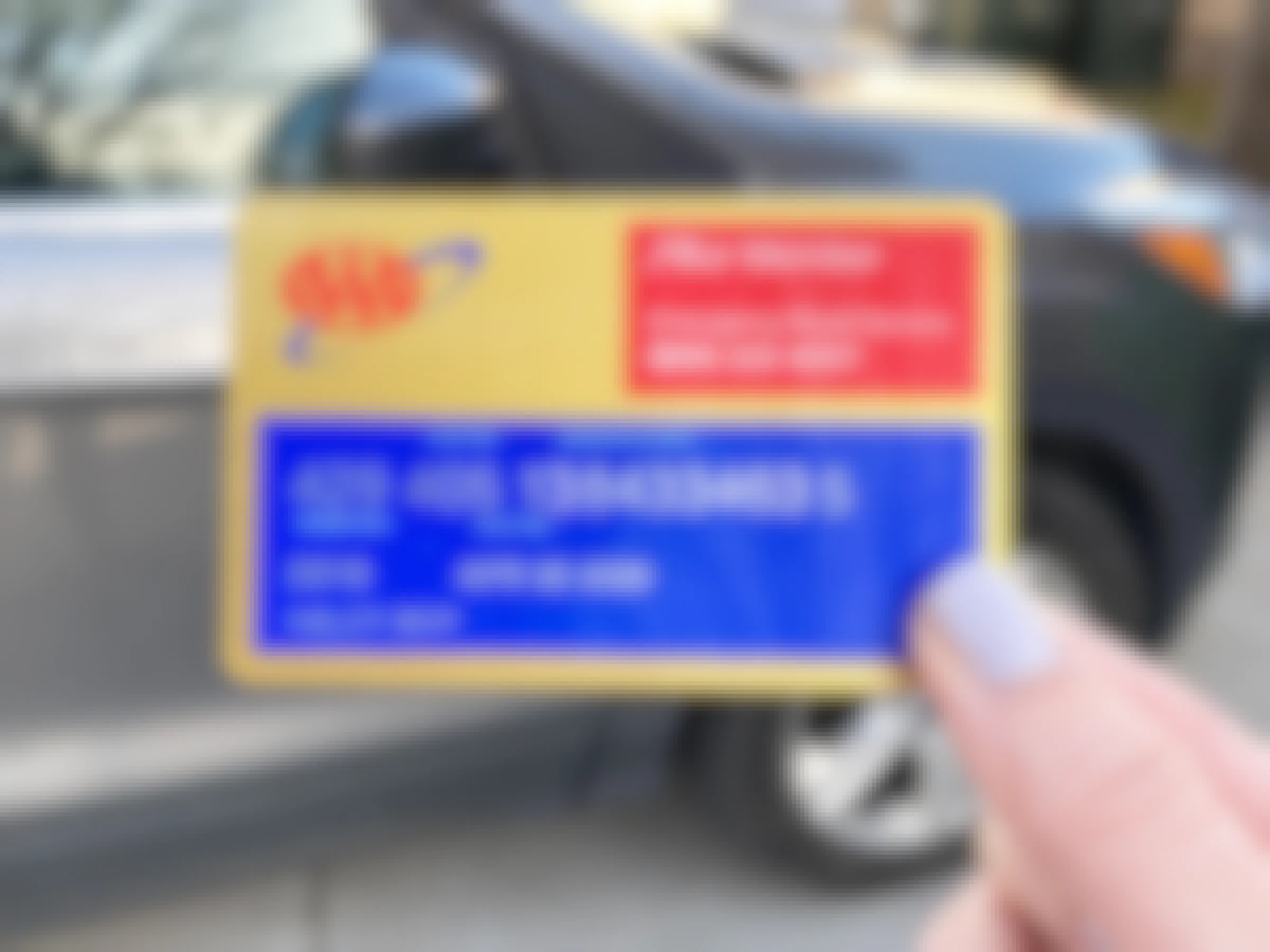 AAA card held in front of a car.