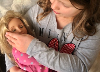 Our Generation Doll being held by a little girl.