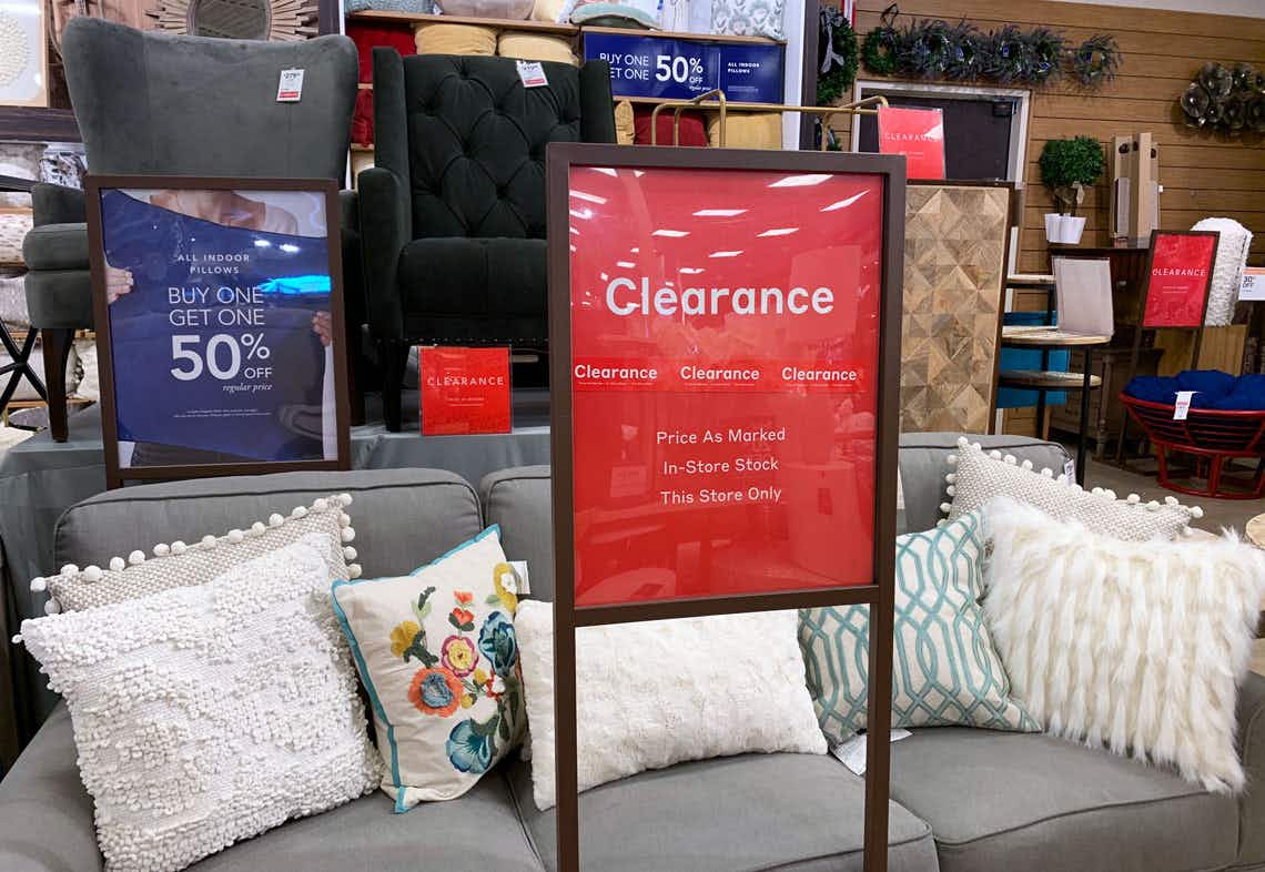 Red Pier 1 clearance sign in store by a couch.