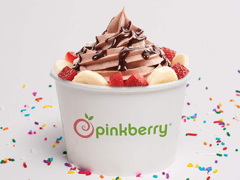 Chocolate froyo with banana and strawberry topping, with chocolate sauce on top.