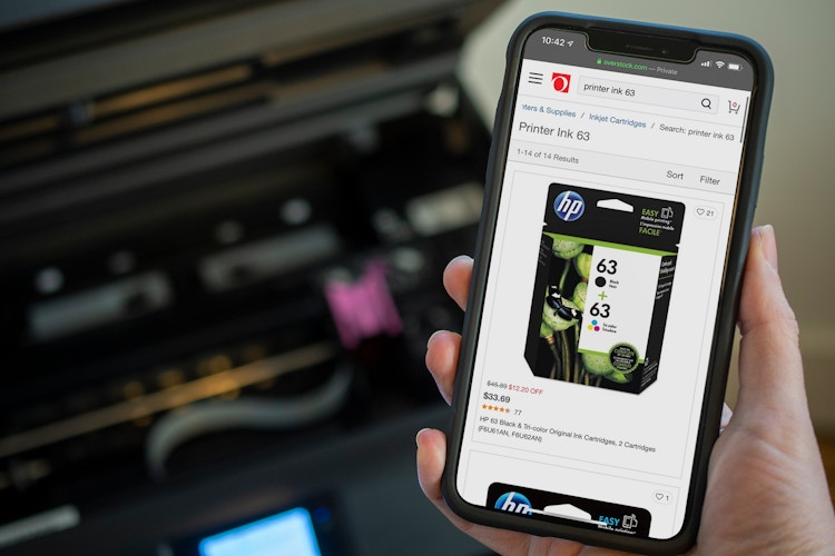 A cell phone displaying printer ink on overstock.com