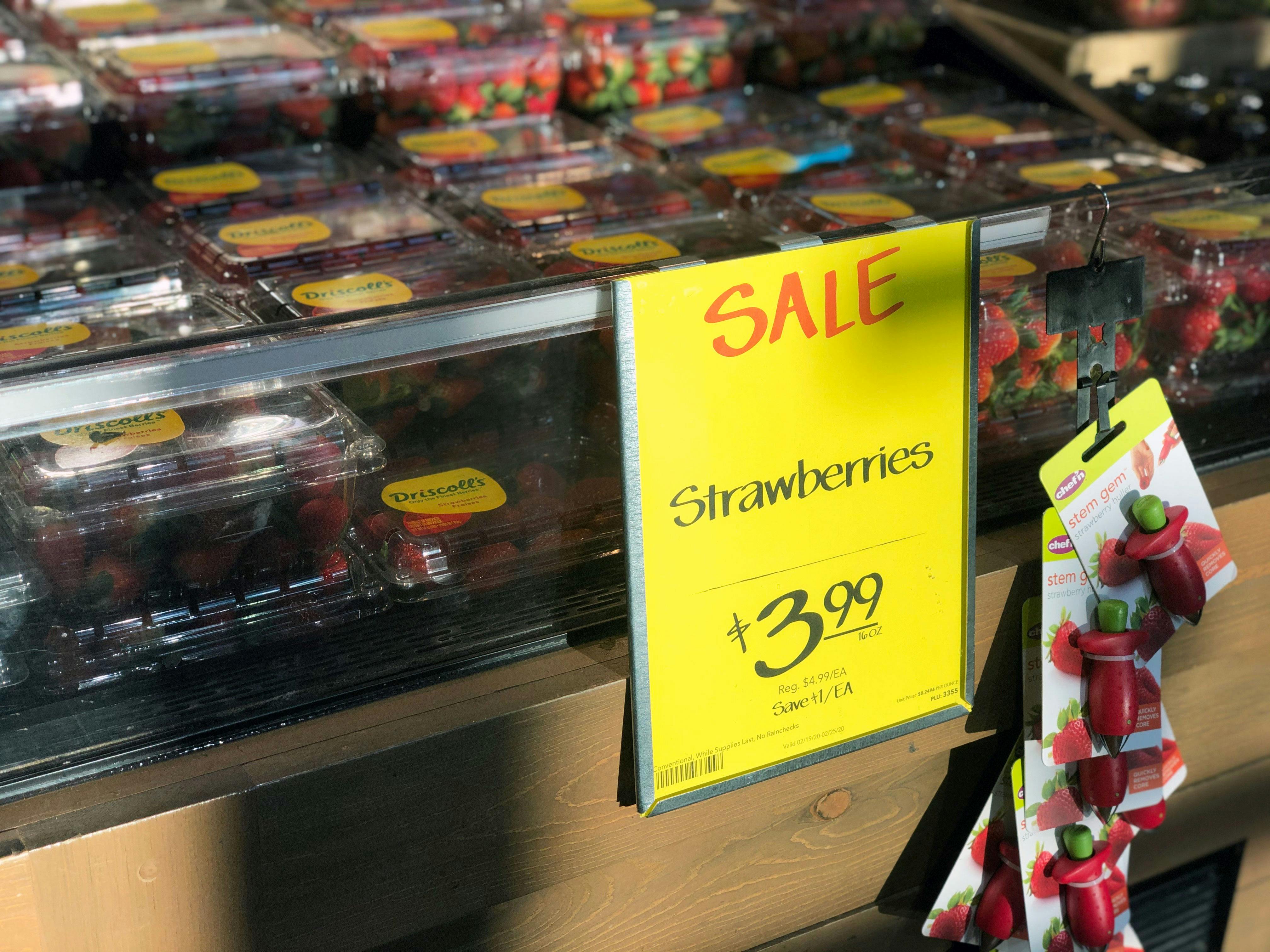 Sale sign attached to a fresh strawberries display