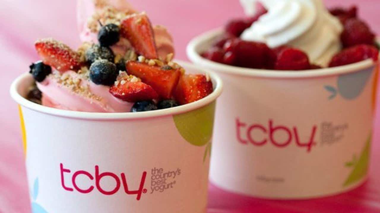 TCBY frozen yogurt with fruit and graham cracker crumbs topping.