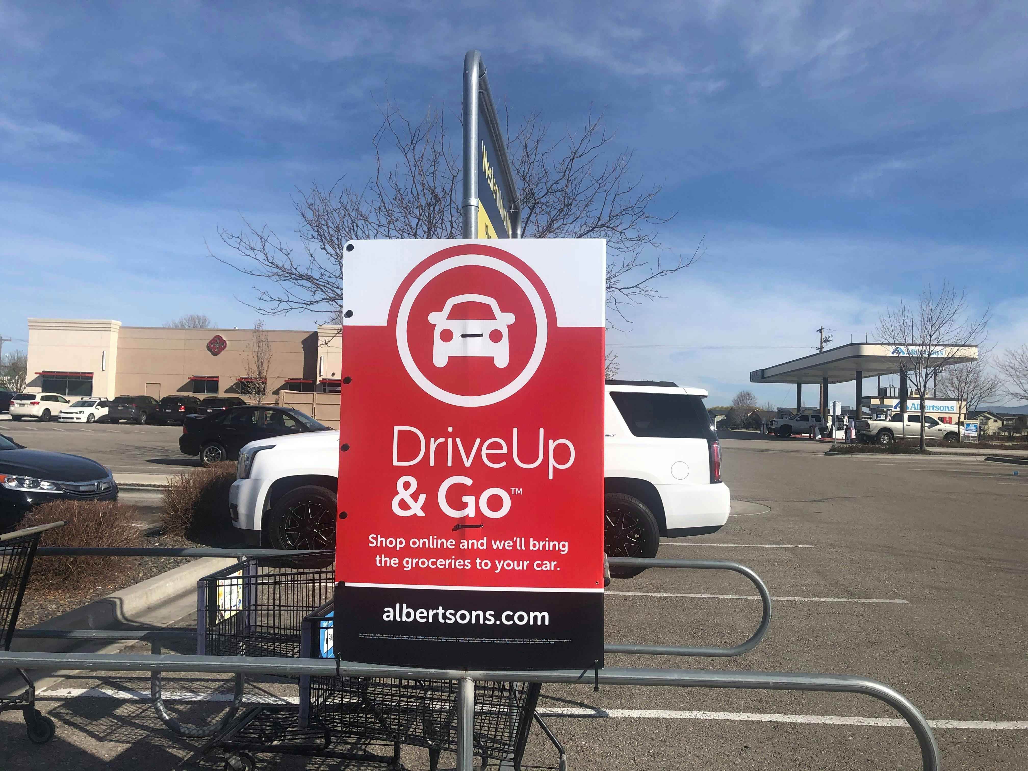 A drive up and go sign outside a store.