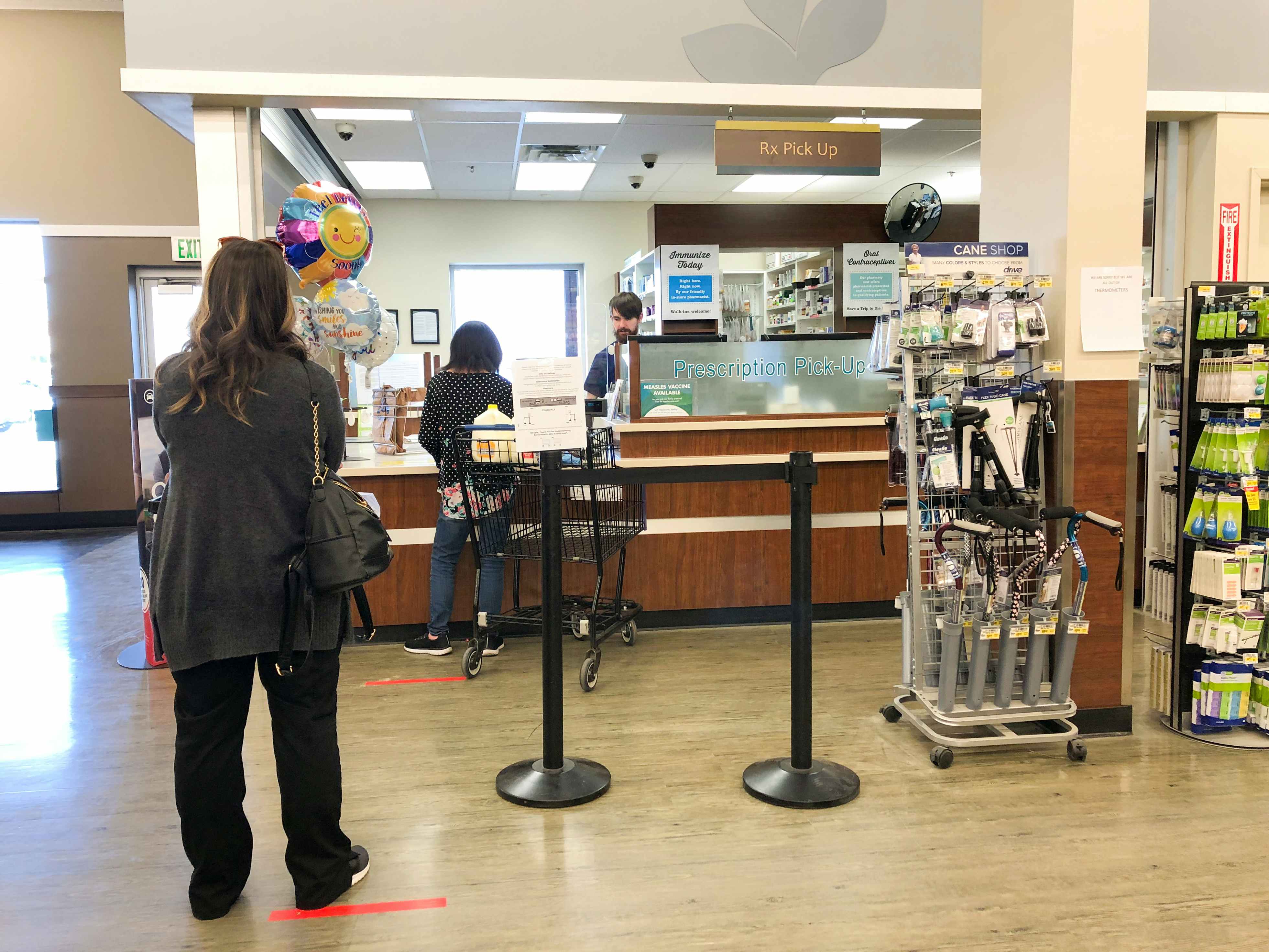 A woman waits in line at the pharmacy at Albertsons.