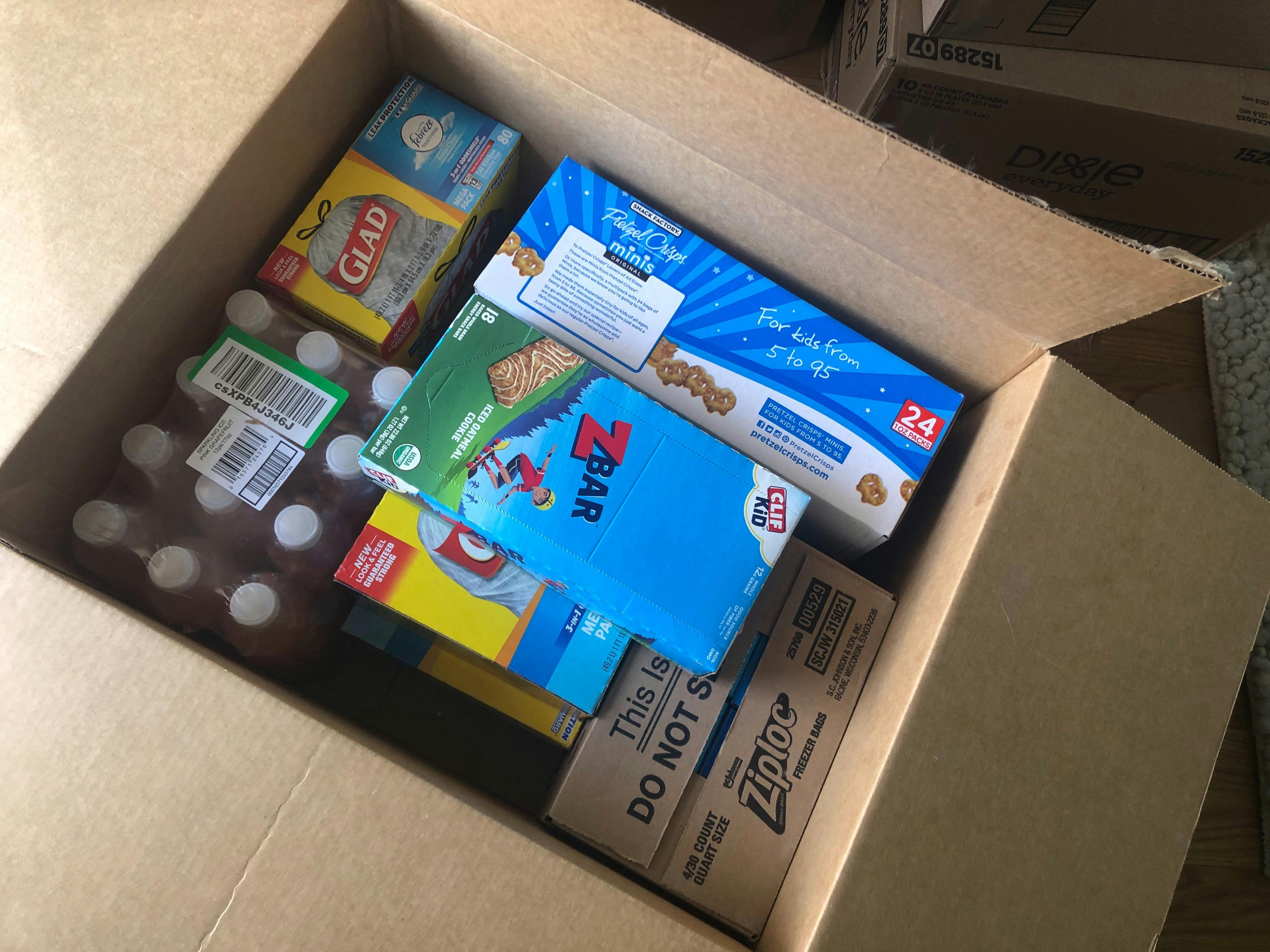 An amazon box filled with home products and snack foods.