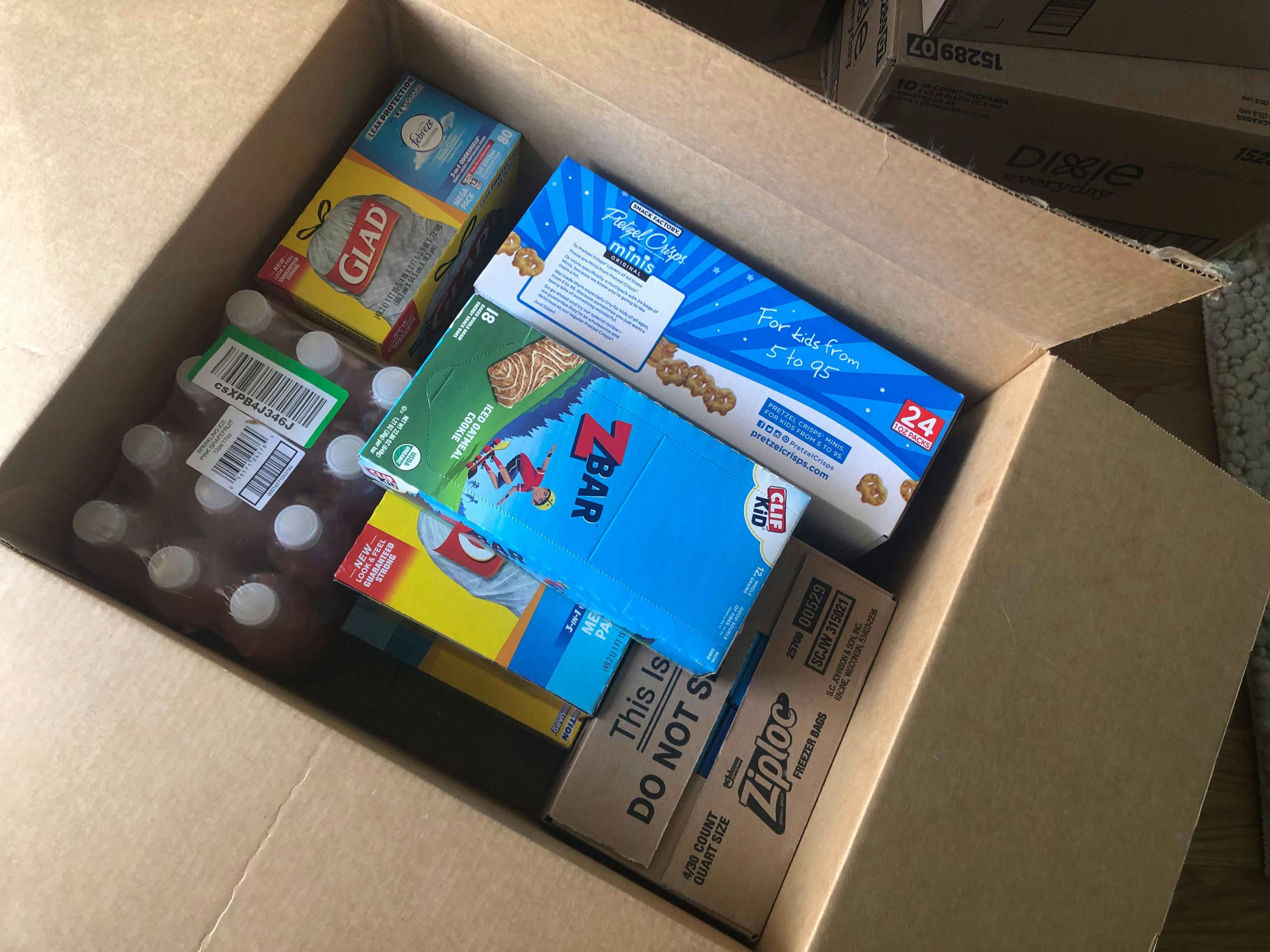 An amazon box filled with home products and snack foods