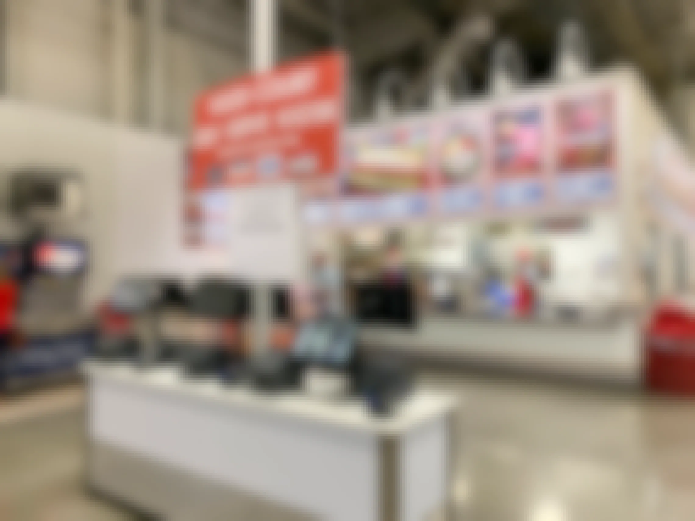 The Costco food court and self-serve kiosks with a sign stating there is a limited menu and available for take out only.