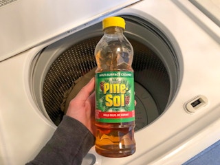 I bottle of Pine Sol over the of a top load washing machine.