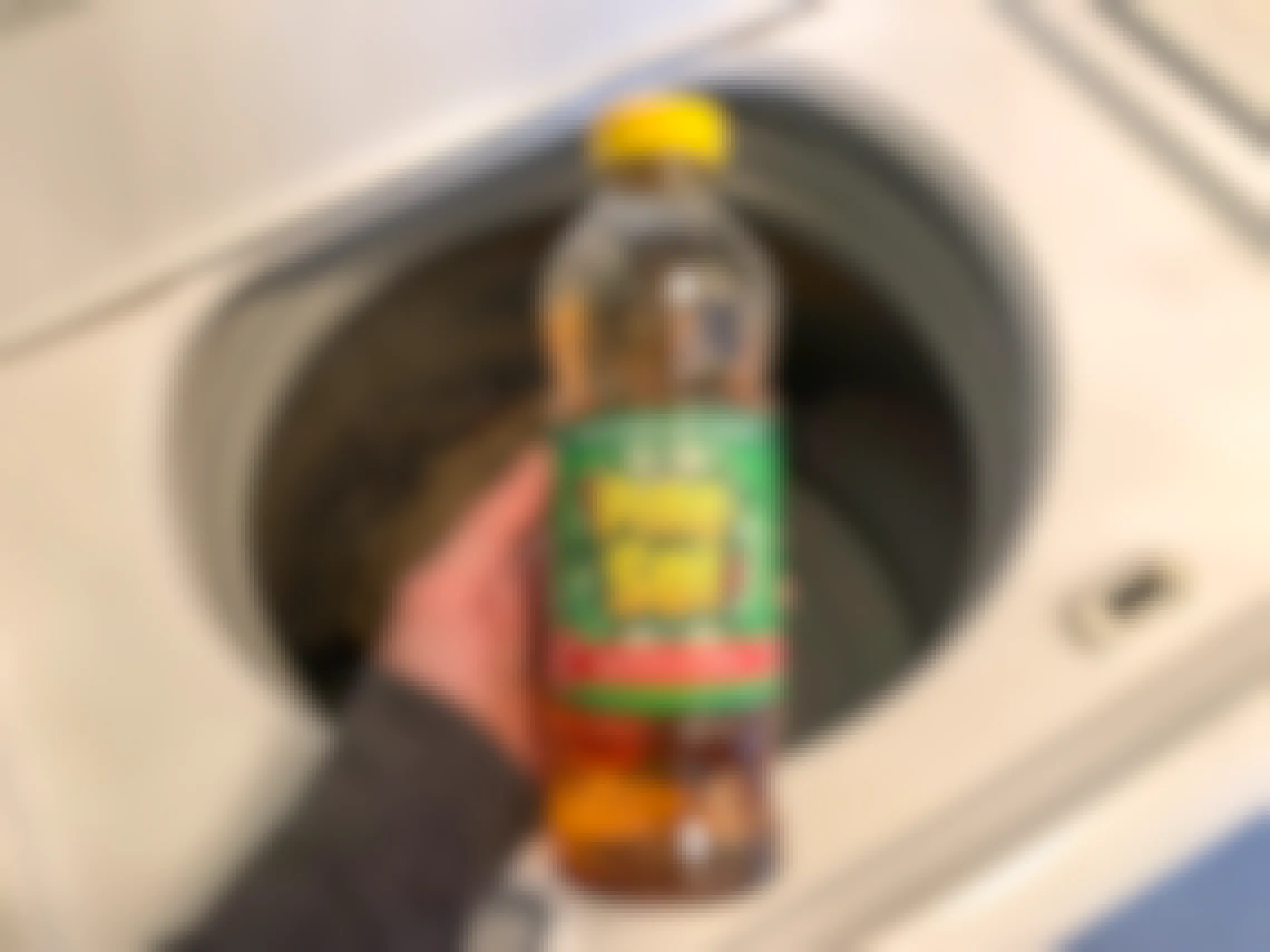 I bottle of Pine Sol over the of a top load washing machine.