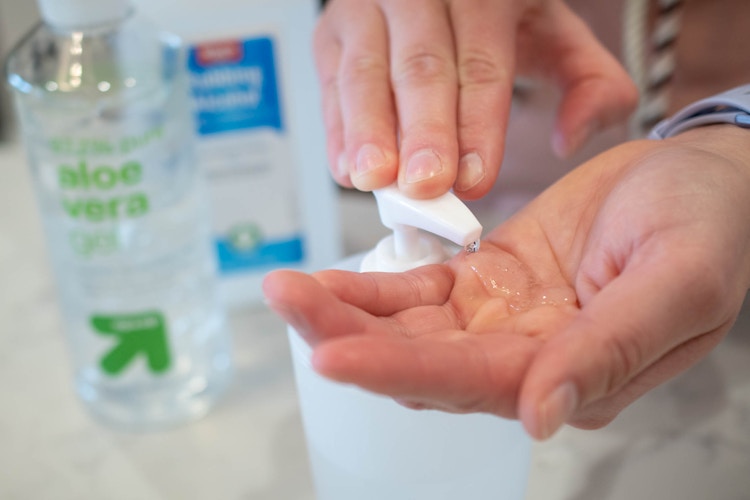 homemade hand sanitizer in a pump bottle someone is using