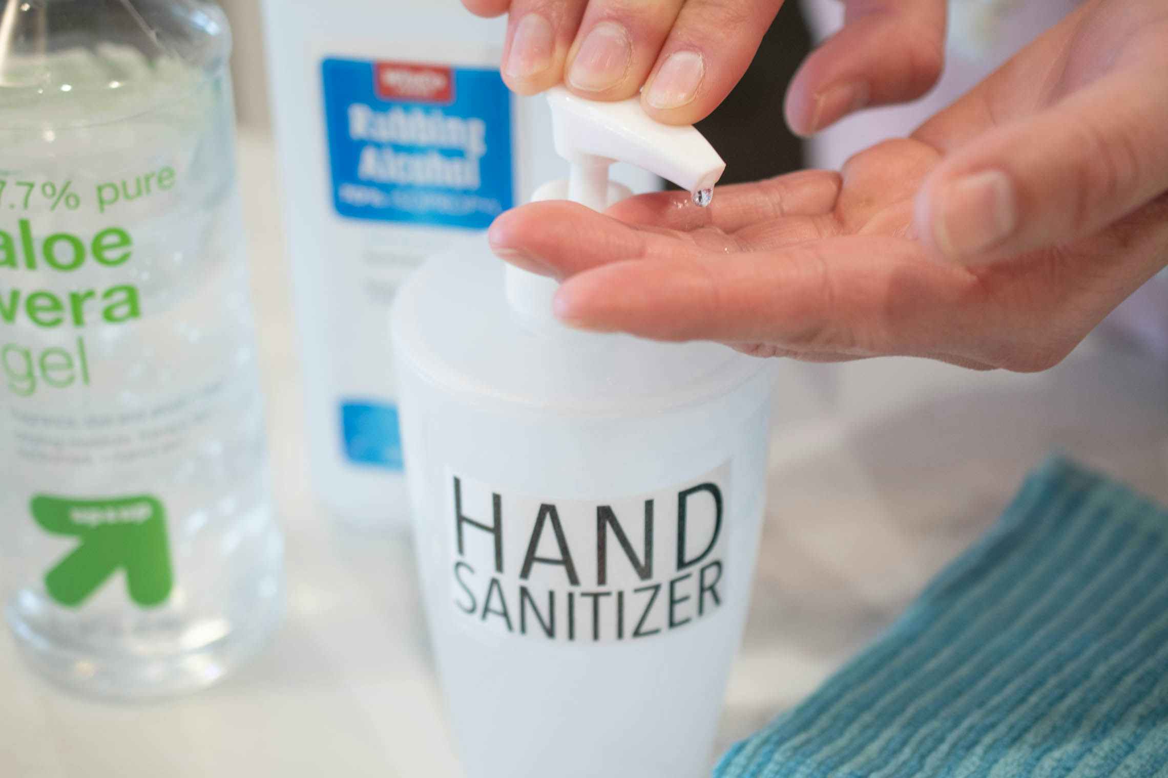 someone putting hand sanitizer on with rubbing alcohol 