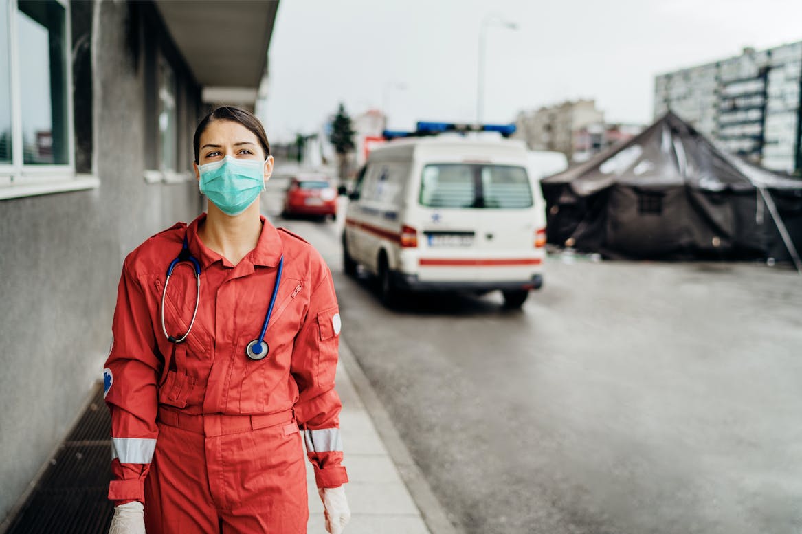 nurse wears a mask outside hospital