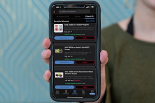 Digital Kroger coupons displayed on an iphone in someones hand.
