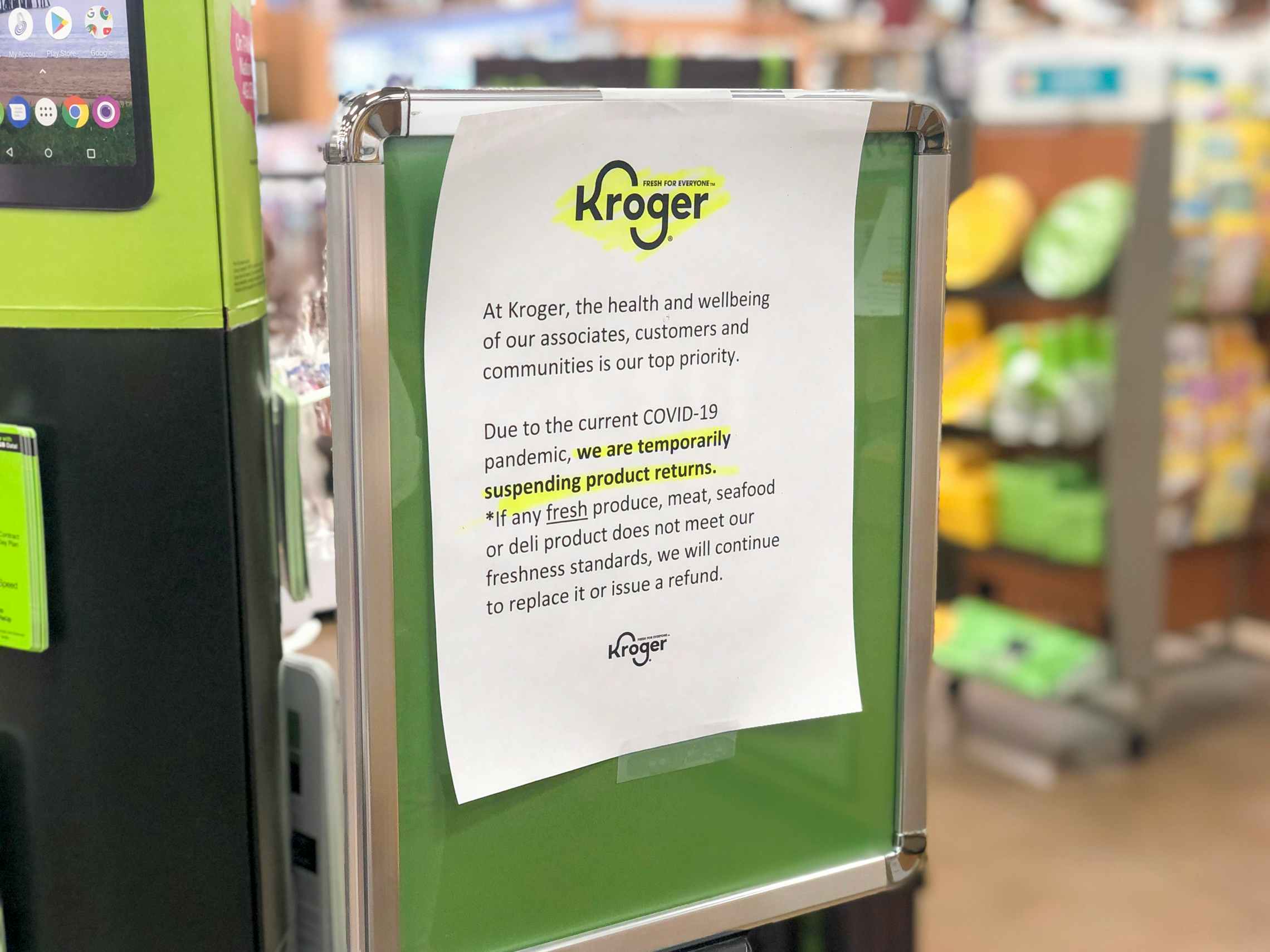 A sign inside a Kroger store, "due to the current Corvid-19 pandemic, we are temporarily suspending product returns.