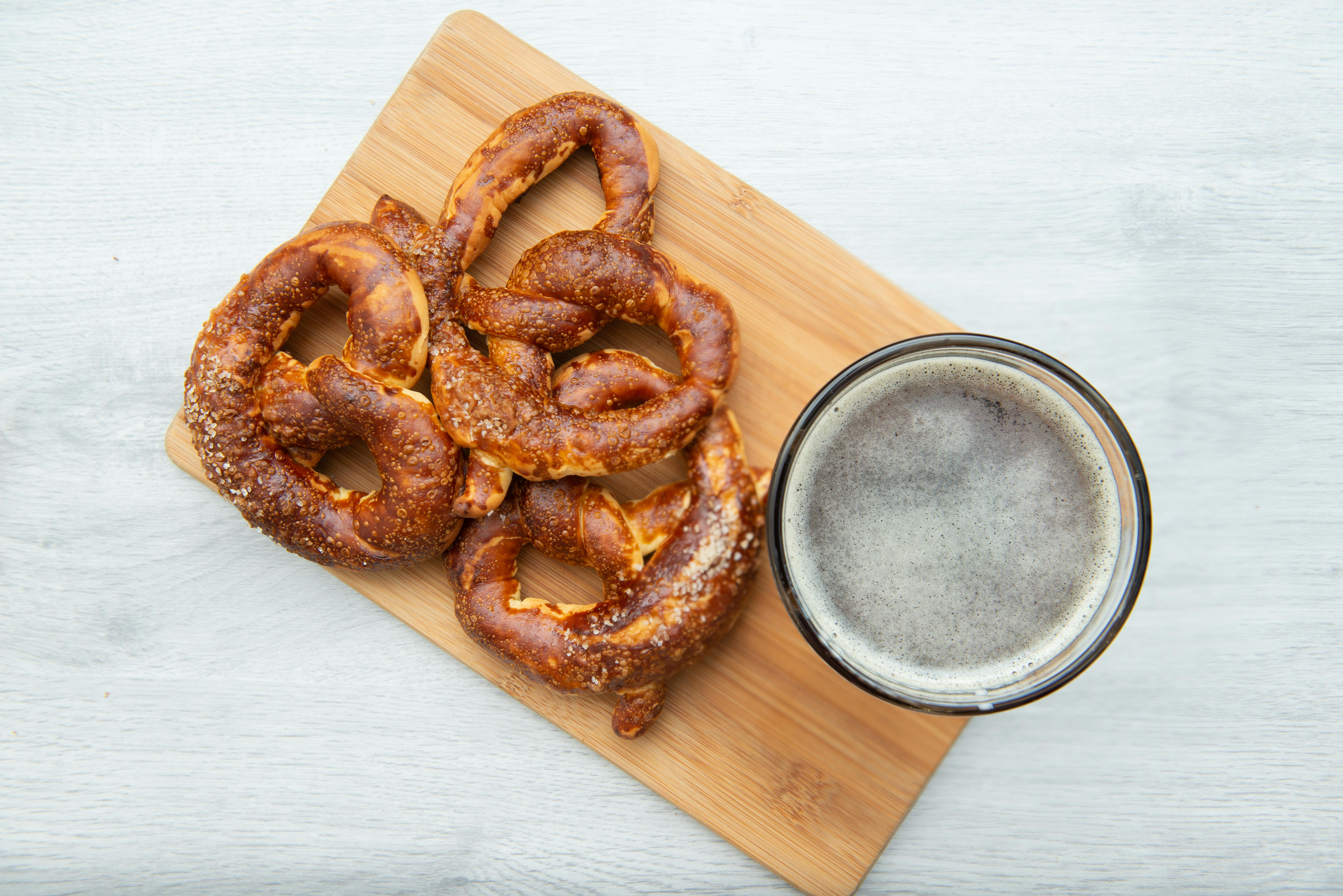 A soft pretzel on a cutting board.