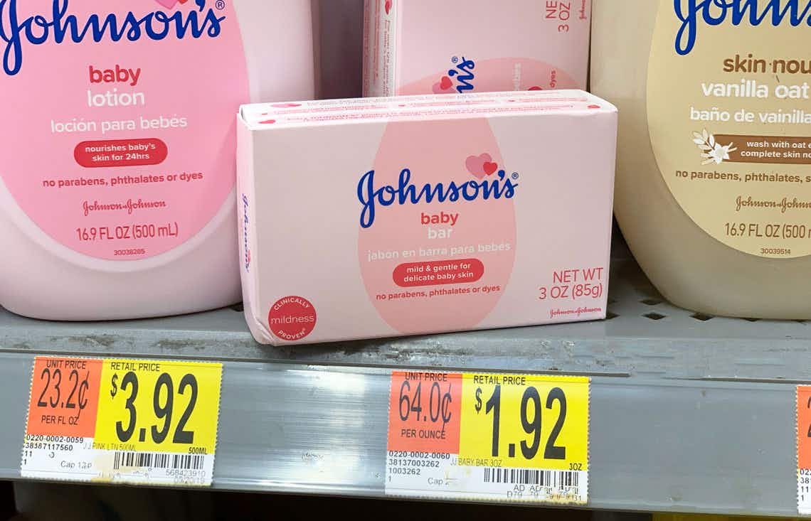 single pack of johnson's baby bar in a pink box being held by a left hand in front of the walmart shelf showing the price tag