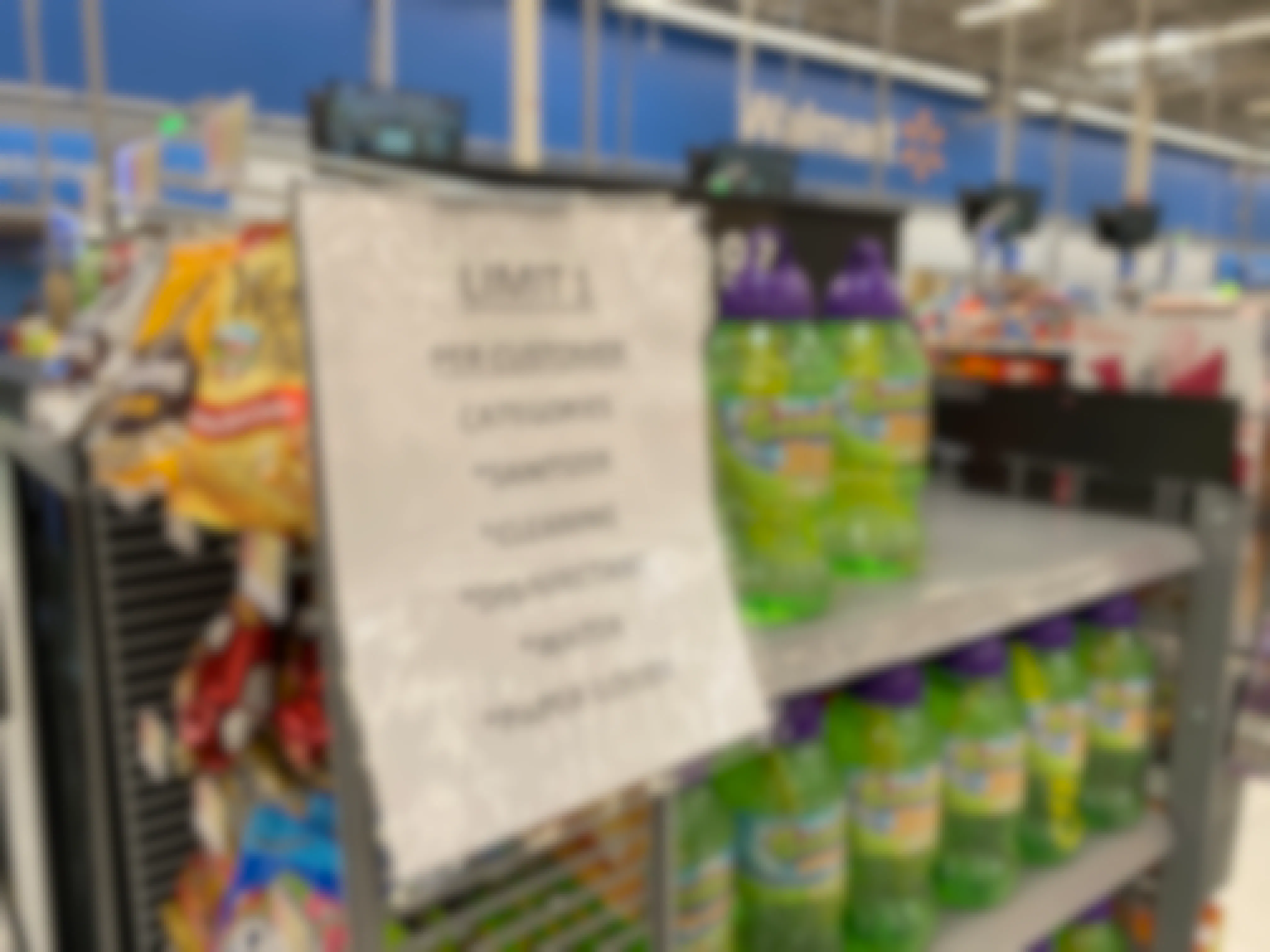 A sign inside Walmart with a list of items that are limited, 1 per customer.