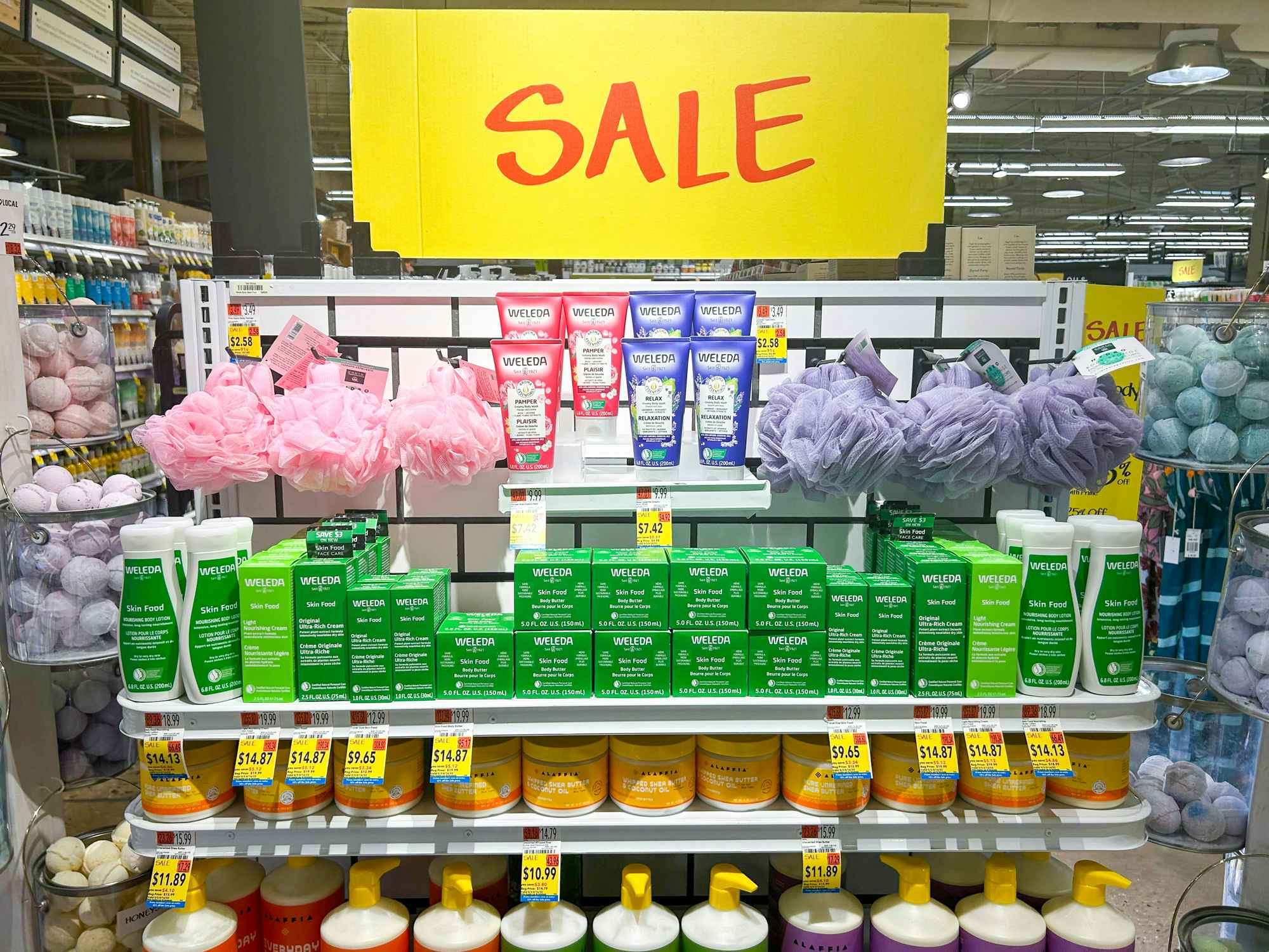 A shelf of body care items in Whole Foods with large SALE signs