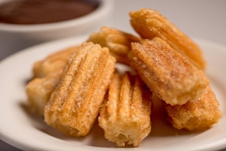 Churros sitting on a plate