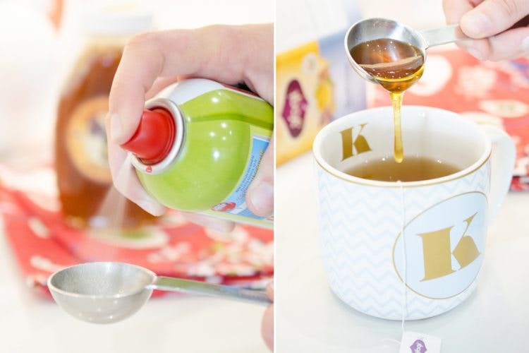 Person-spraying-nonstick-spray-into-measuring-spoon-next-to-a-measuring-spoon-pouring-honey-into-tea-cup
