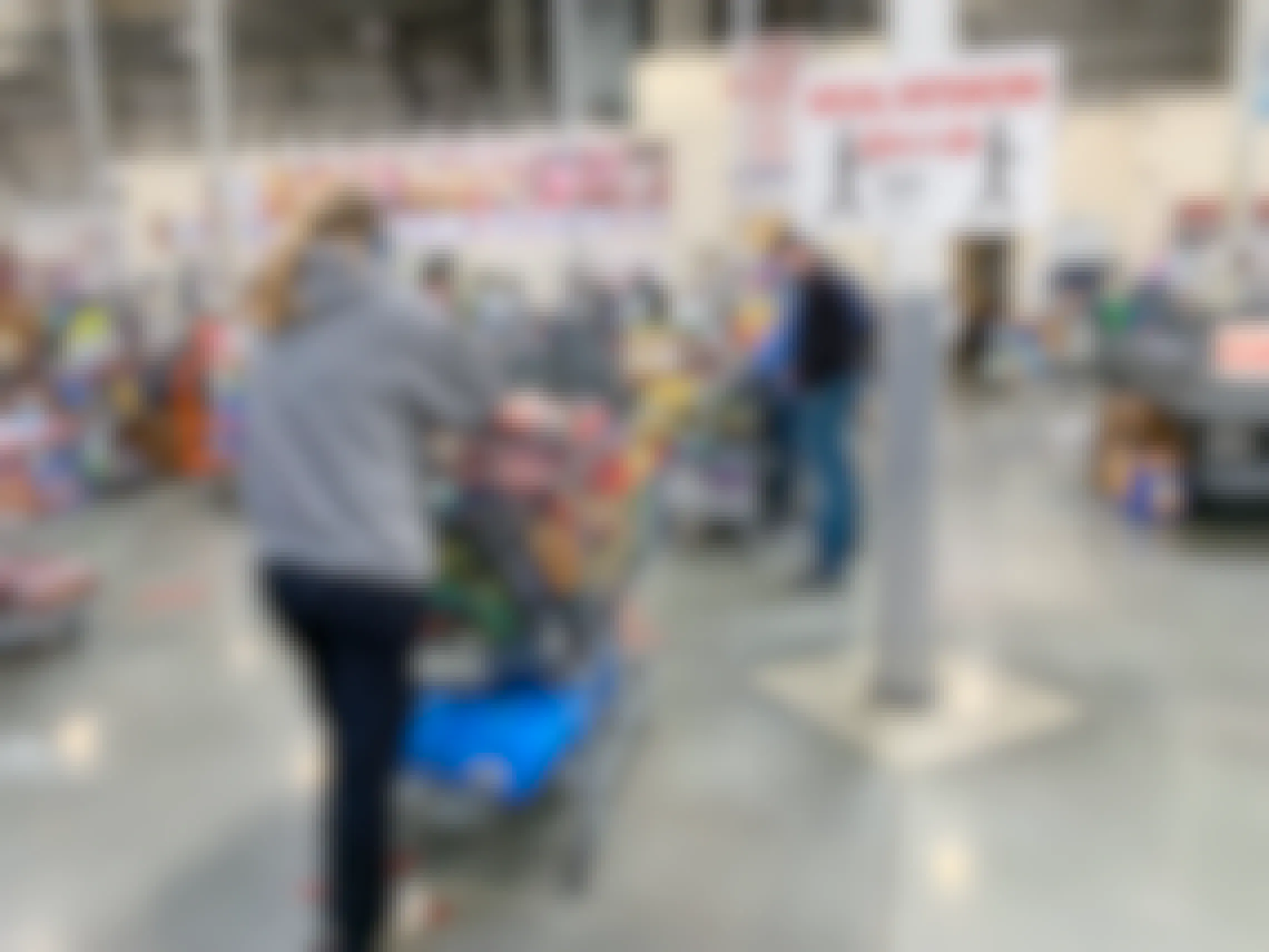 Costco checkout line with social distancing sign.