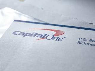 A close up of a Capital One envelope with a bill in it.