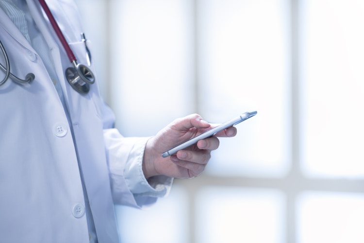 A doctor holding a smartphone