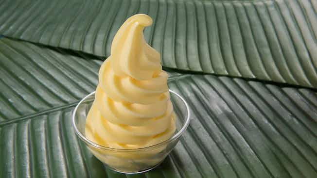 Disney Dole whip in a bowl on top of banana leaves