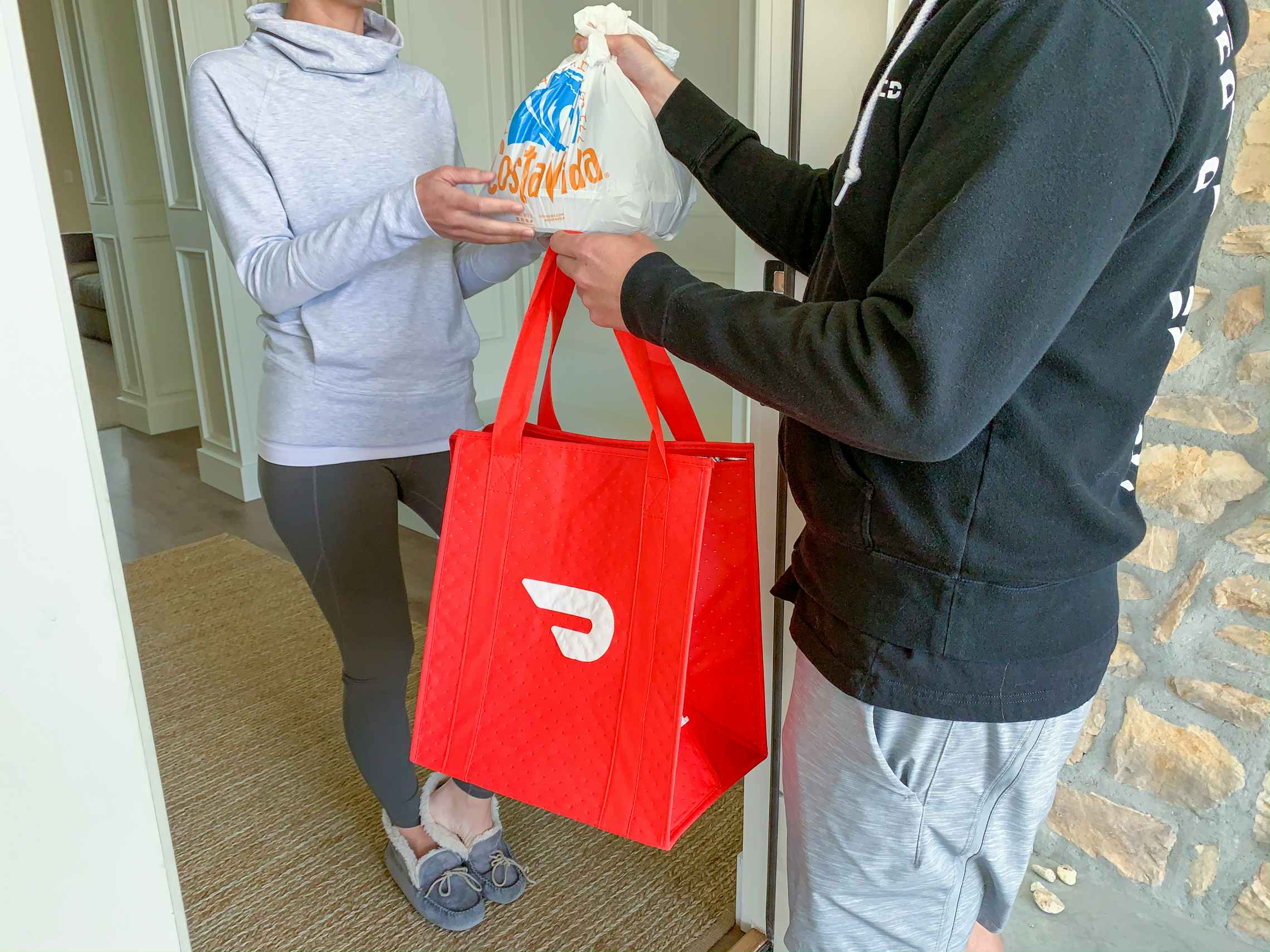 A man delivering costa vida via door dash.