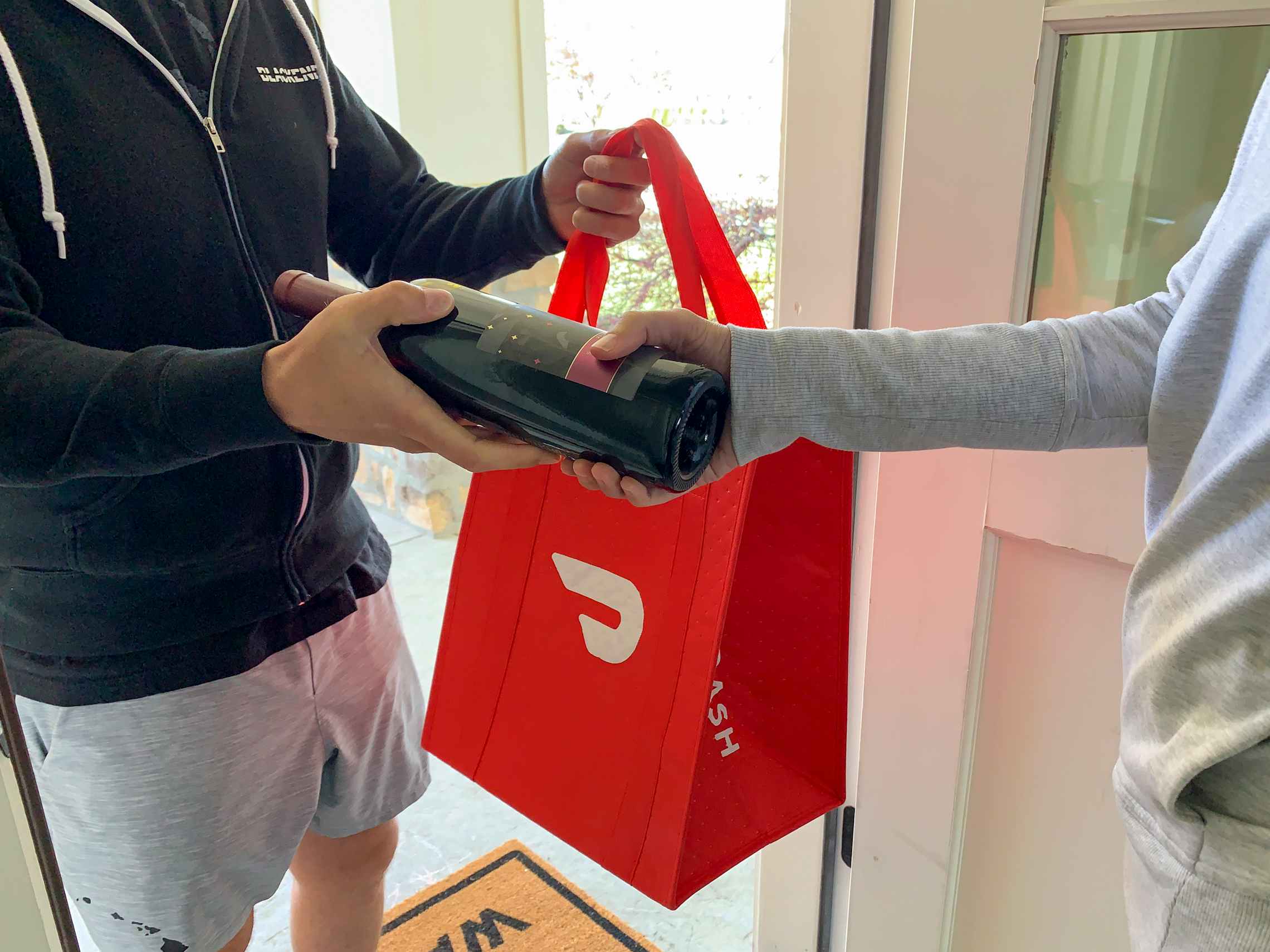 A man delivering wine via doordash.