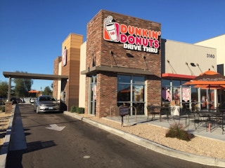 A car goes through a Dunkin' Donuts drive-thru
