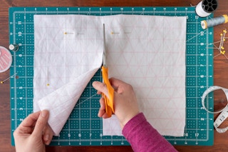 Cutting the fabric along the pin lines.