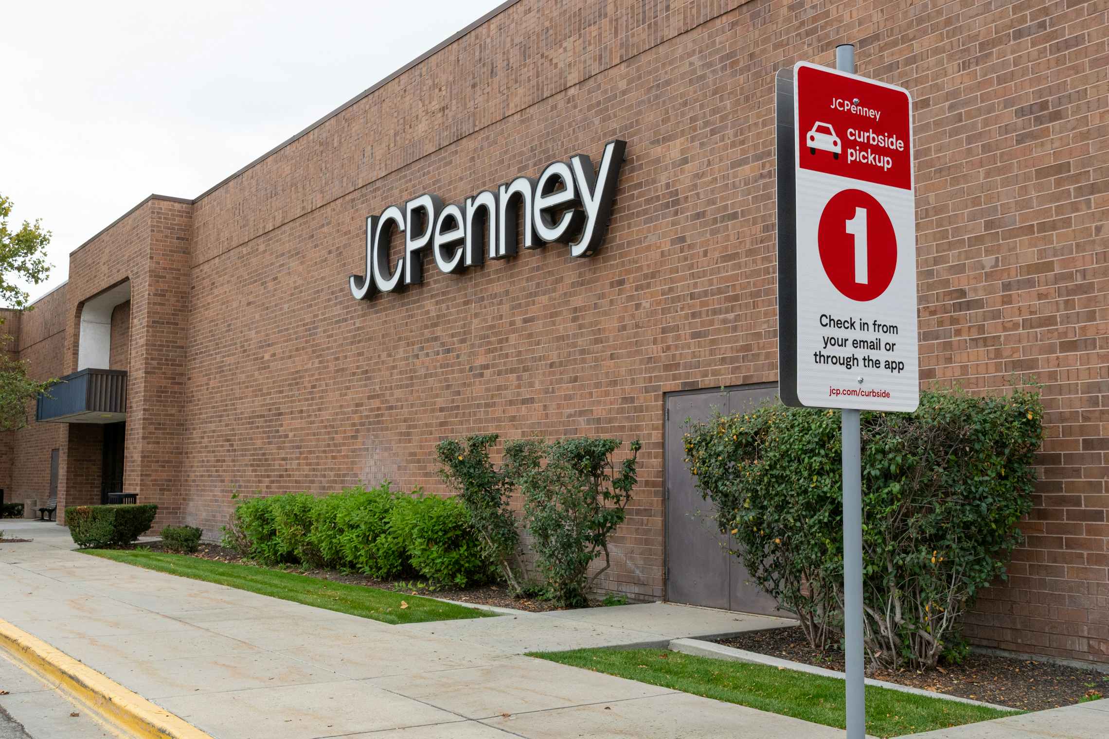 JCPenny store front with curbside pickup sign