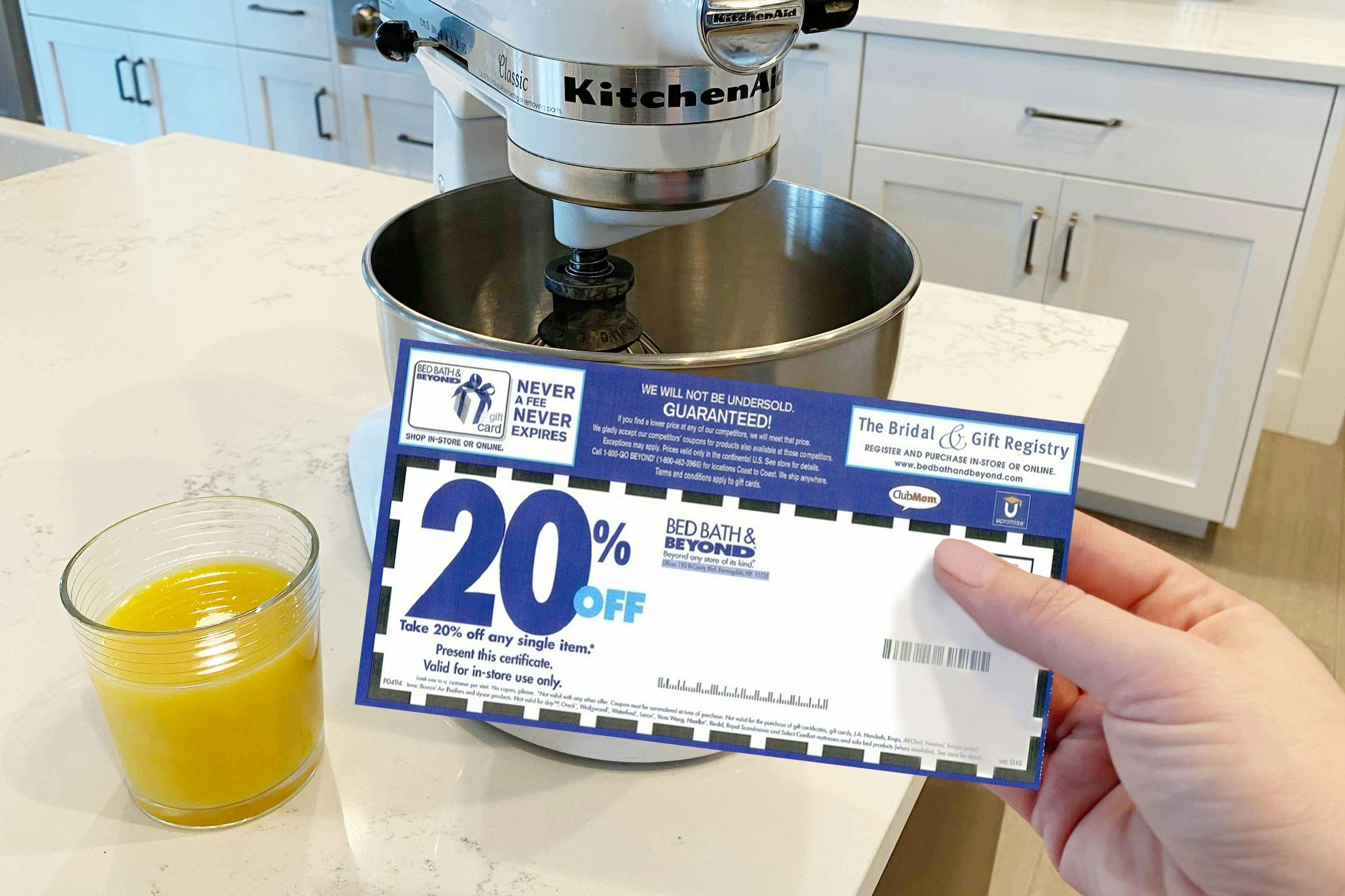 A Bed Bath and Beyond coupon in front of a Kitchenaid