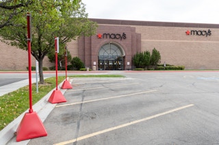 Macy's store front with curbside pickup signs