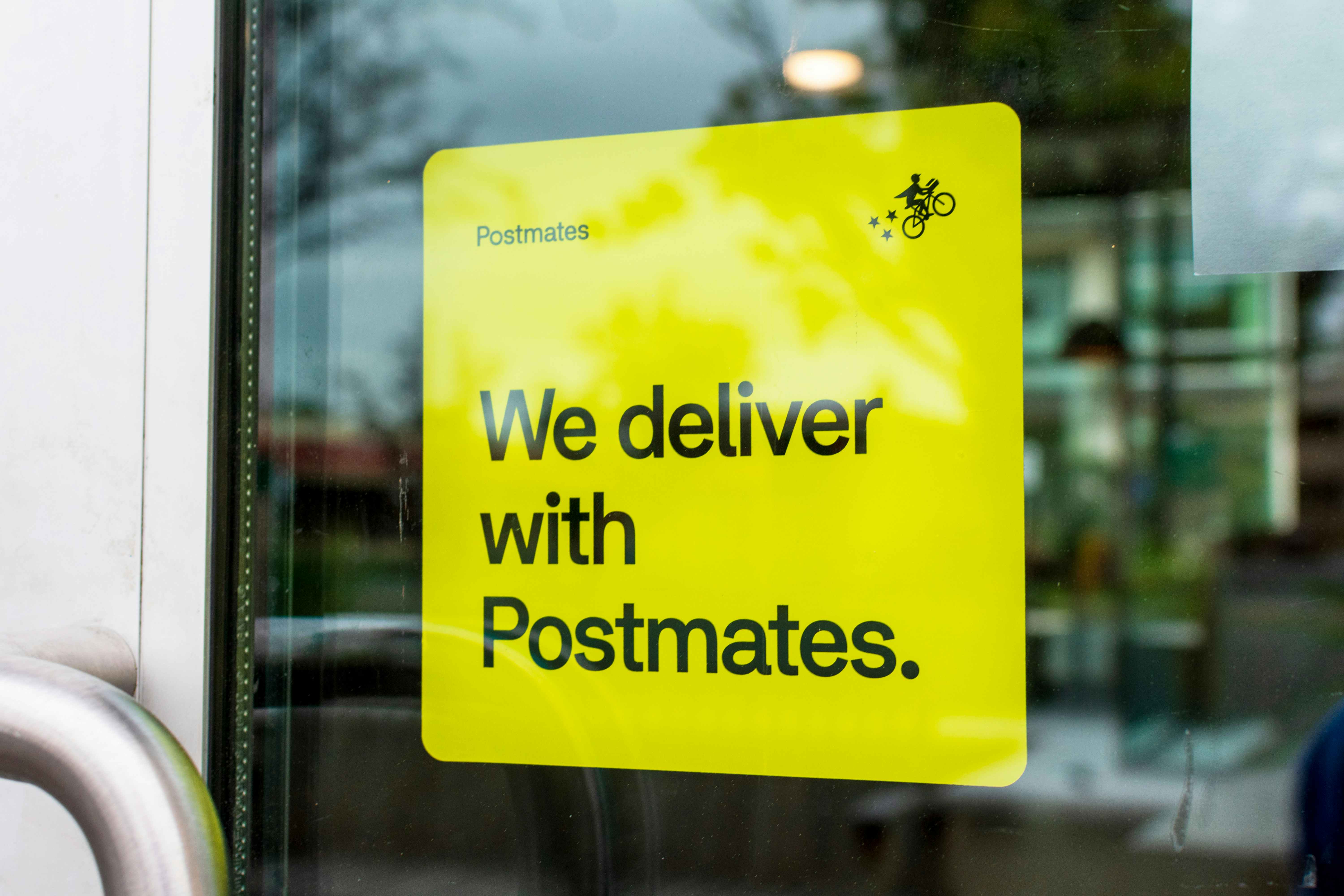postmates sign in a window