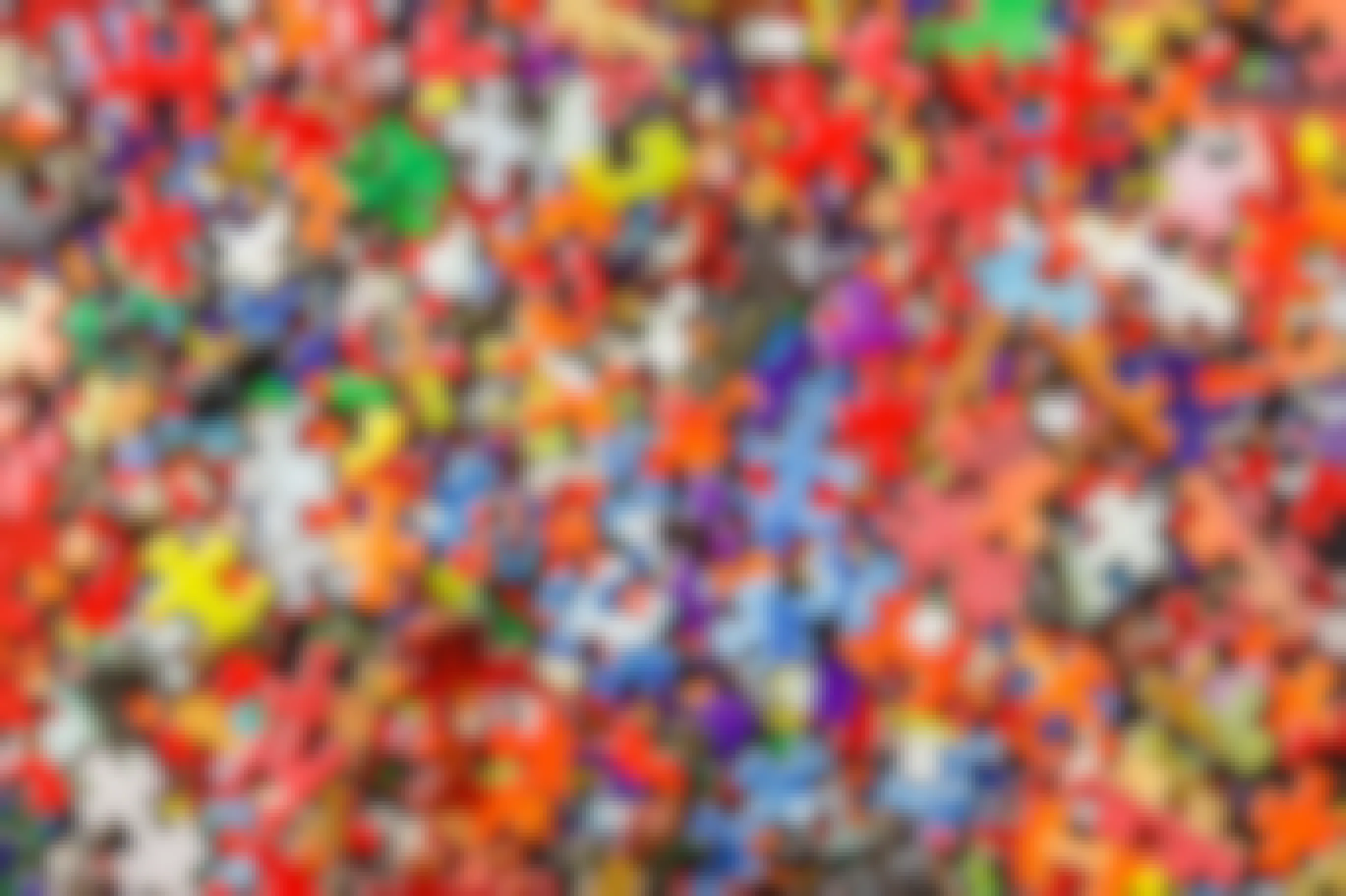 Large pile of bright, multicolored puzzle pieces.