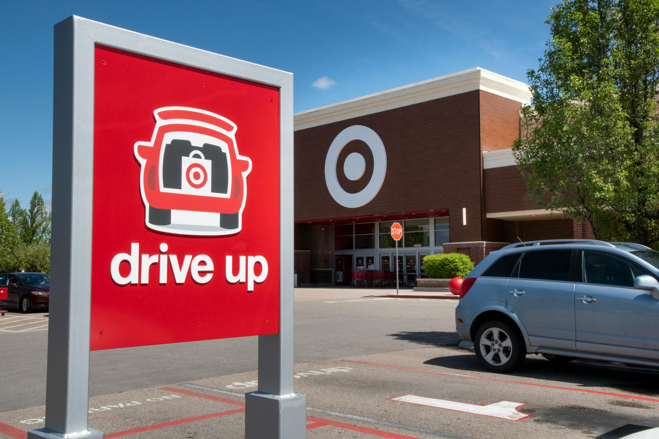 A Target drive up/order pickup sign in the parking lot in front of Target.