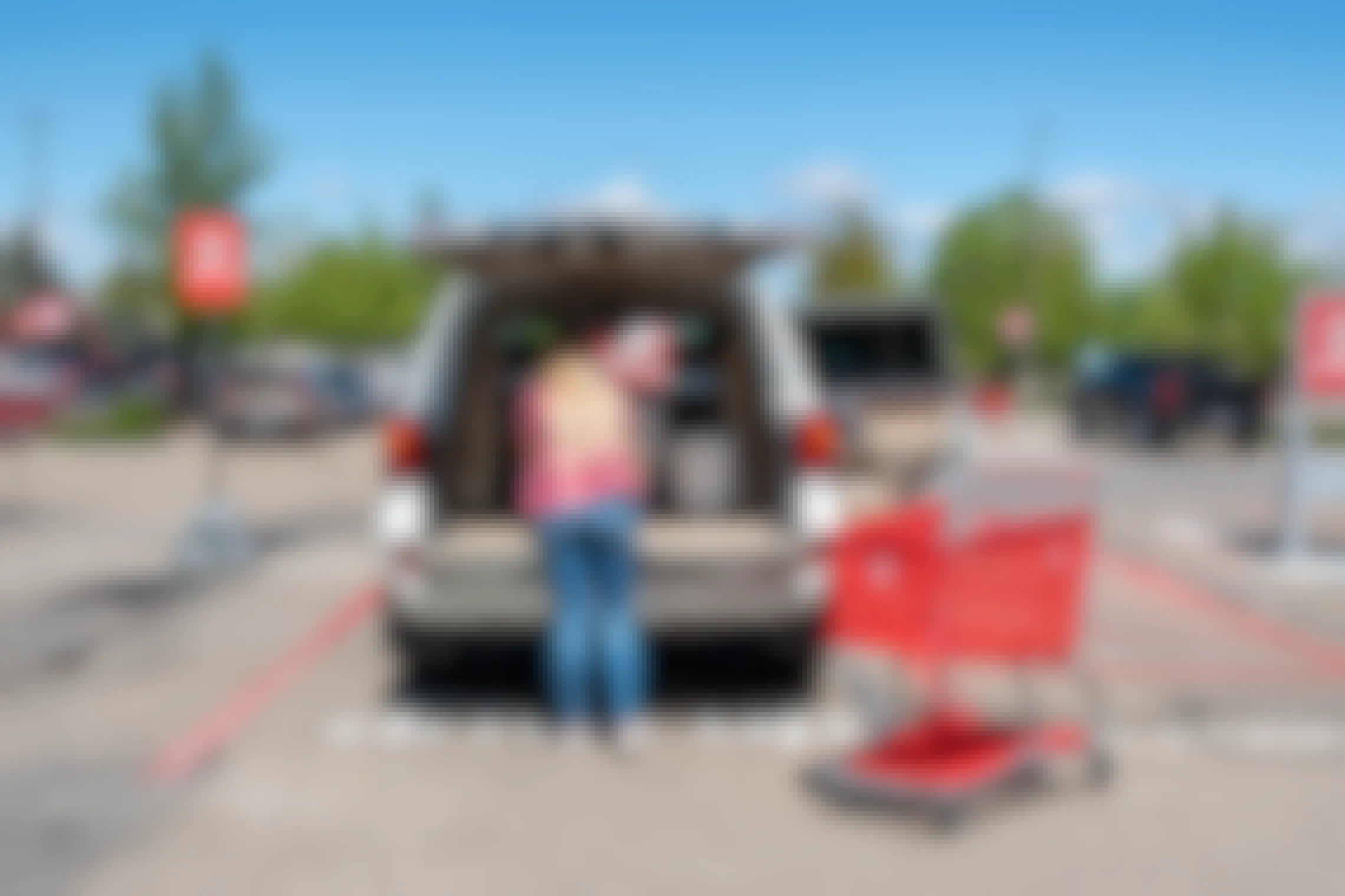 A target employee putting items in the back of an SUV.